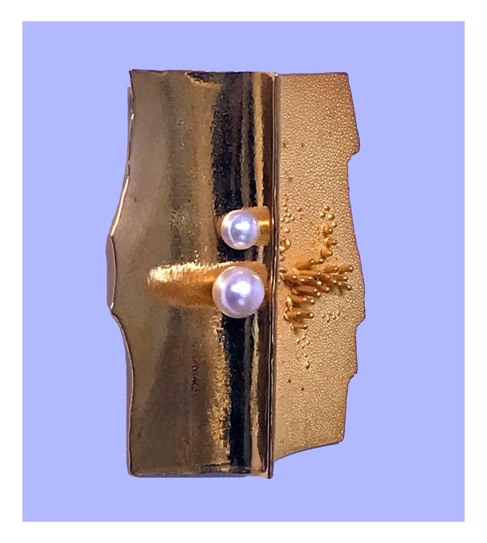 Walter Schluep 18-karat abstract brooch pin, circa 1970. Depicting possibly textured sand with pebbles and polished undulating waves with two fine cultured pearls. Fully signed on reverse 18K W. Schluep and stamped W 1968 Avi. Spanish born, Geneva