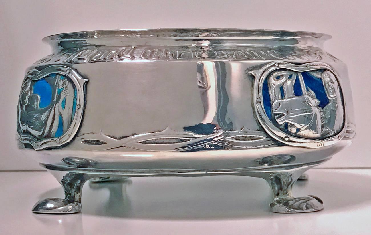 Rare liberty silver and enamel rose bowl, Birmingham, 1902, stamped Cymric Liberty & Company and stamped 2028. The bowl on four lily pad supports, the body with four enamel and silver applied cartouches to the sides with figures of Romeo and Juliet,