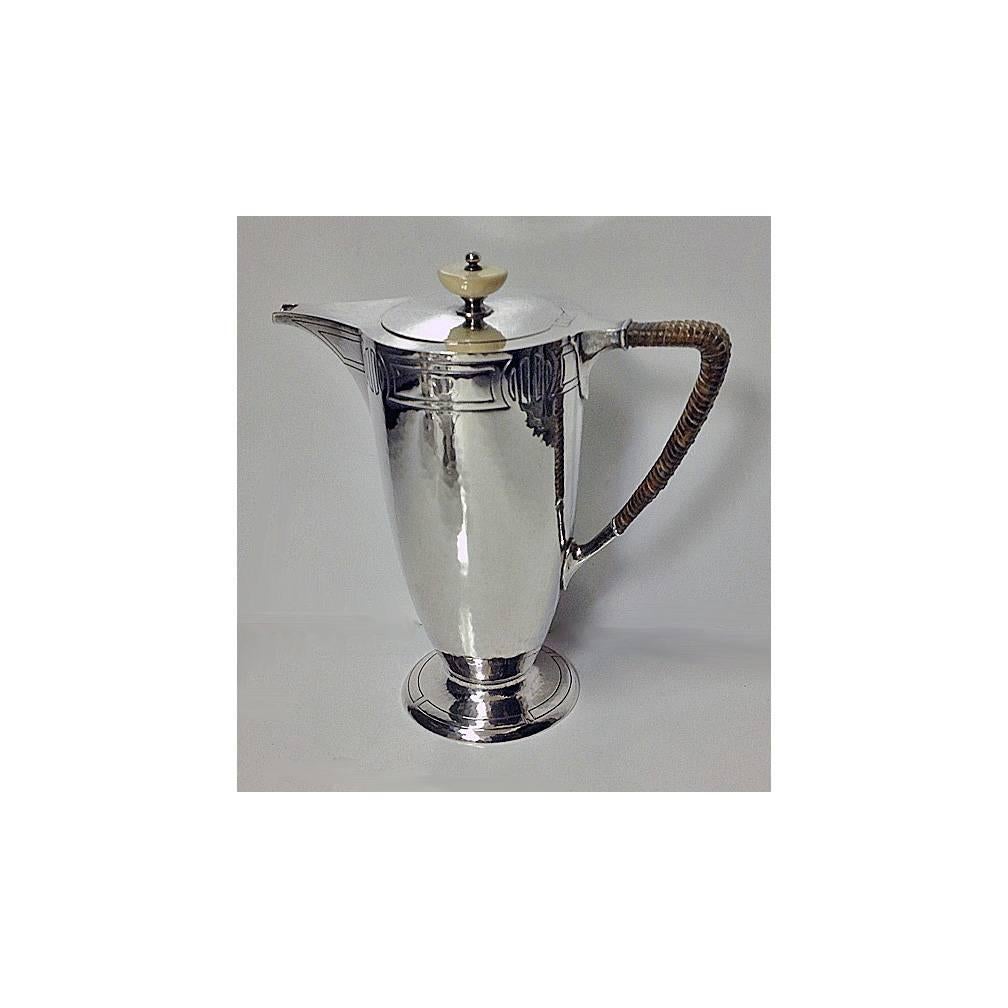 American Arts & Crafts sterling hammered silver coffee service, circa 1905, Wm. Durgin Co, Providence, Rhode Island. The Service of hand beaten design, each piece on a spreading circular footed base, the upper and lower parts of the body with