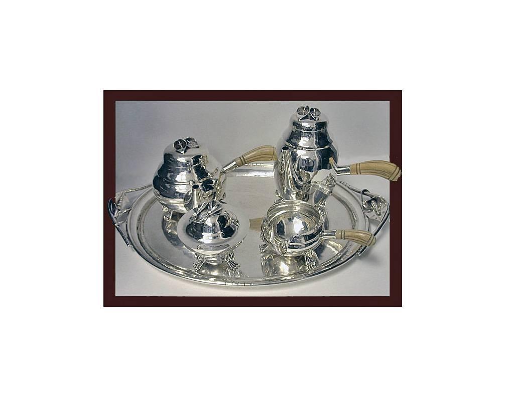 American 5 piece hand made Sterling Tea & Coffee Service, C.1940 by William deMatteo. The Service comprising of a Coffee Pot, Teapot, Sugar & Cream , each on 3 turned feet, hammered design body, carved handles, 