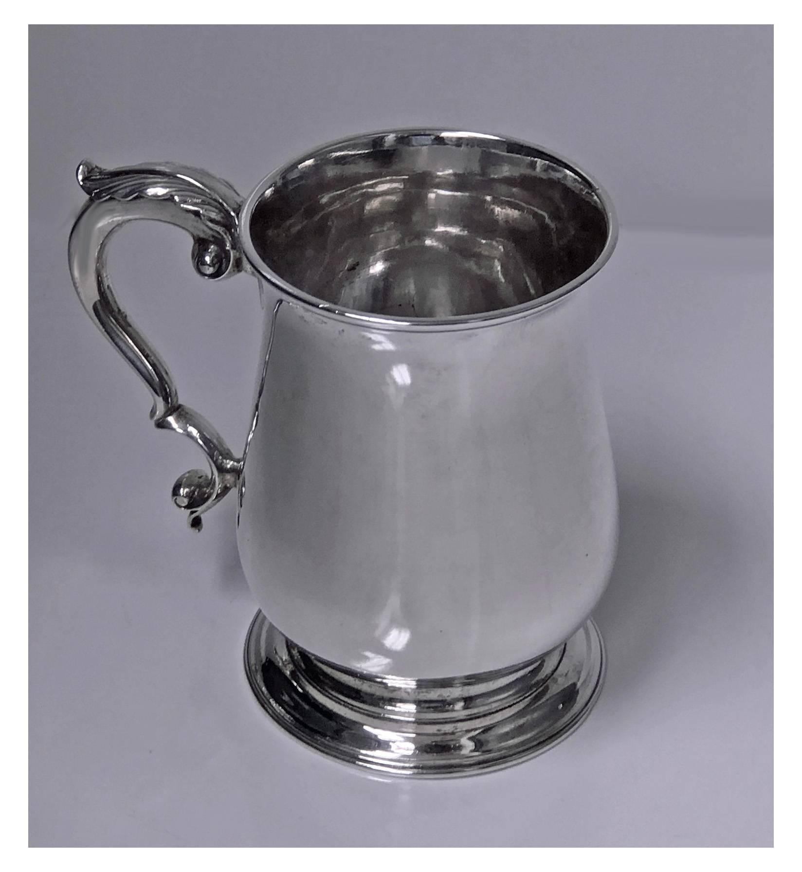 18th century Georgian silver large Mug, London 1771, makers mark ID. The mug on round pedestal base plain baluster body, acanthus foliate capped double scroll handle. Measures: Height 5 inches. Weight 485.94 grams.