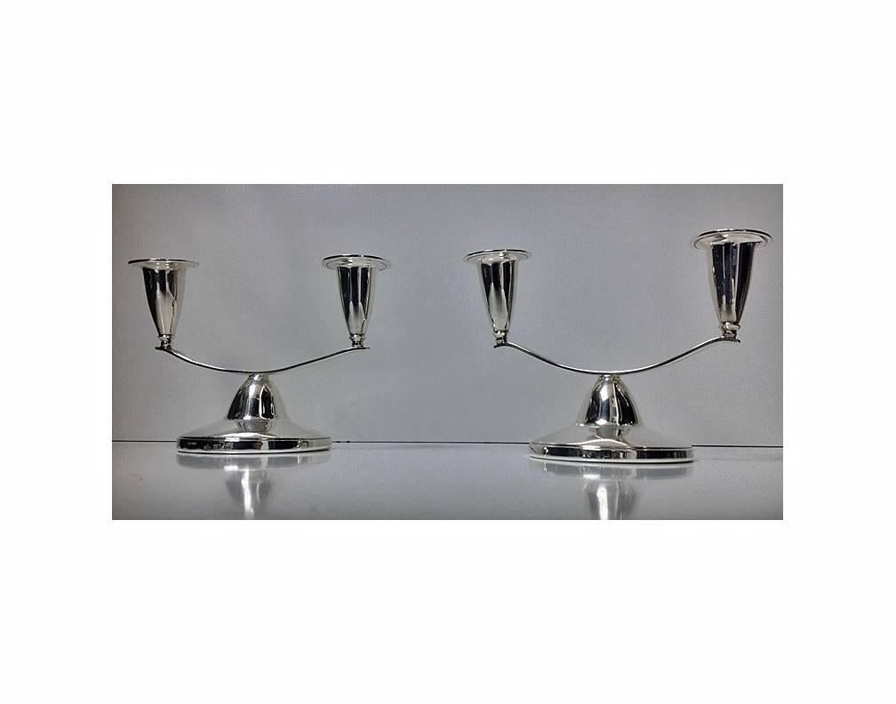 Pair of Elkington silver modernism candlesticks candelabra, Birmingham 1964-1965. Each on circular dome loaded base supporting a two light slightly offset candle holders. Measures: 6 x 4 1/8 inches.