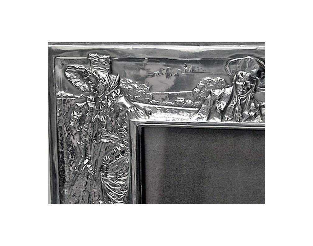 Art Nouveau English Silver Photograph Frame, Birmingham 1906, James Deakin. The Frame depicting Dickensian scenes in Art Nouveau decoration, wood easel back. Fully hallmarked and Registered Patent No 478817. Overall Measures: 10.25 x 7.50 inches.