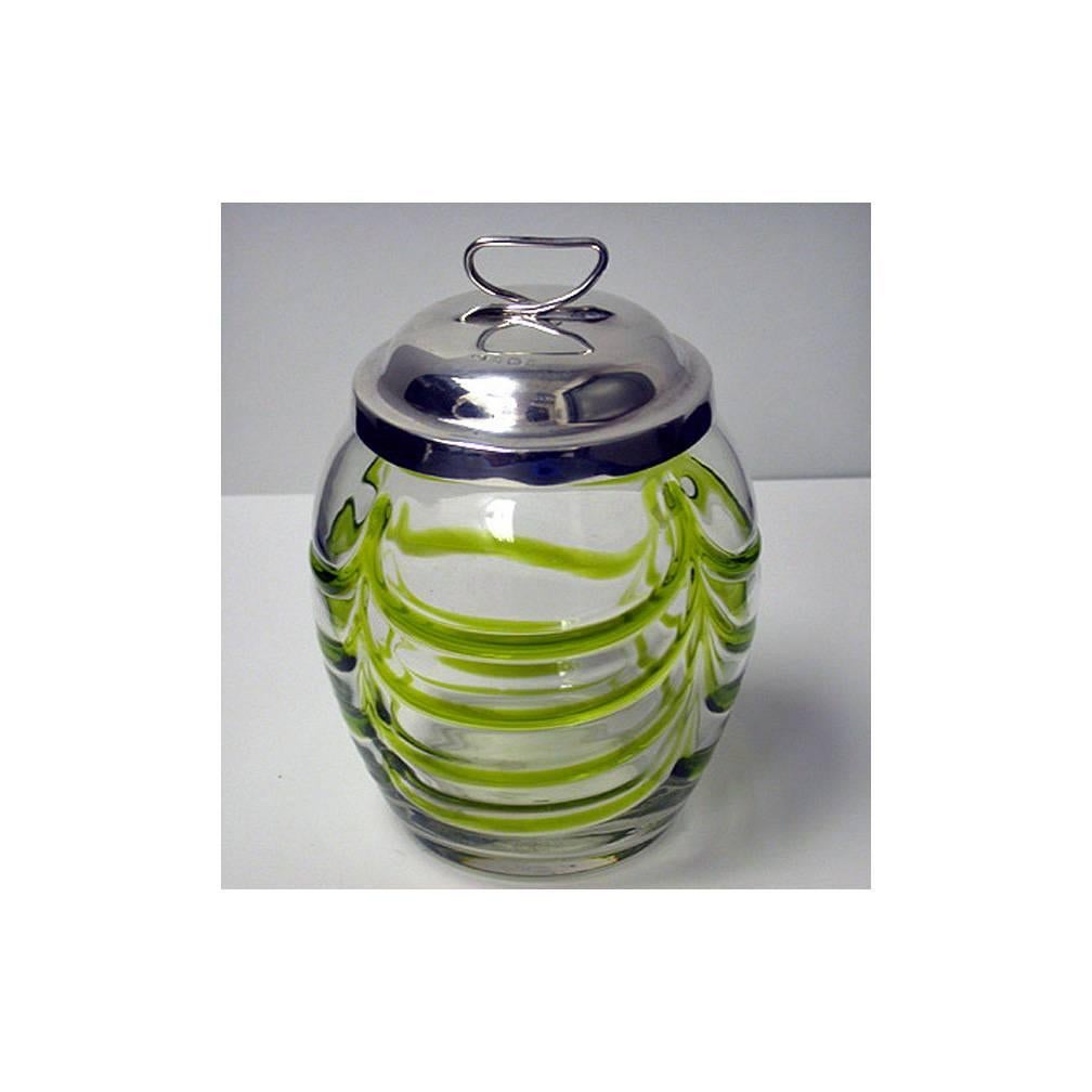 Art Nouveau silver and glass Honey Pot, Birmingham 1906, probably Henry Bourne. The honey jar of beehive form, clear with swirling emerald green trail surround, the silver hallmarked cover, dome shape with open stylised finial. Height: Approximately