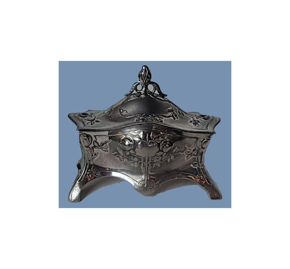 Art Nouveau silver plate jewelry box, Germany, circa 1900 by WMF. The casket box on four turned supports, the undulating body with floral foliate decoration, the hinged cover similarly decorated with stylised bud finial., original lining. WMF Marks
