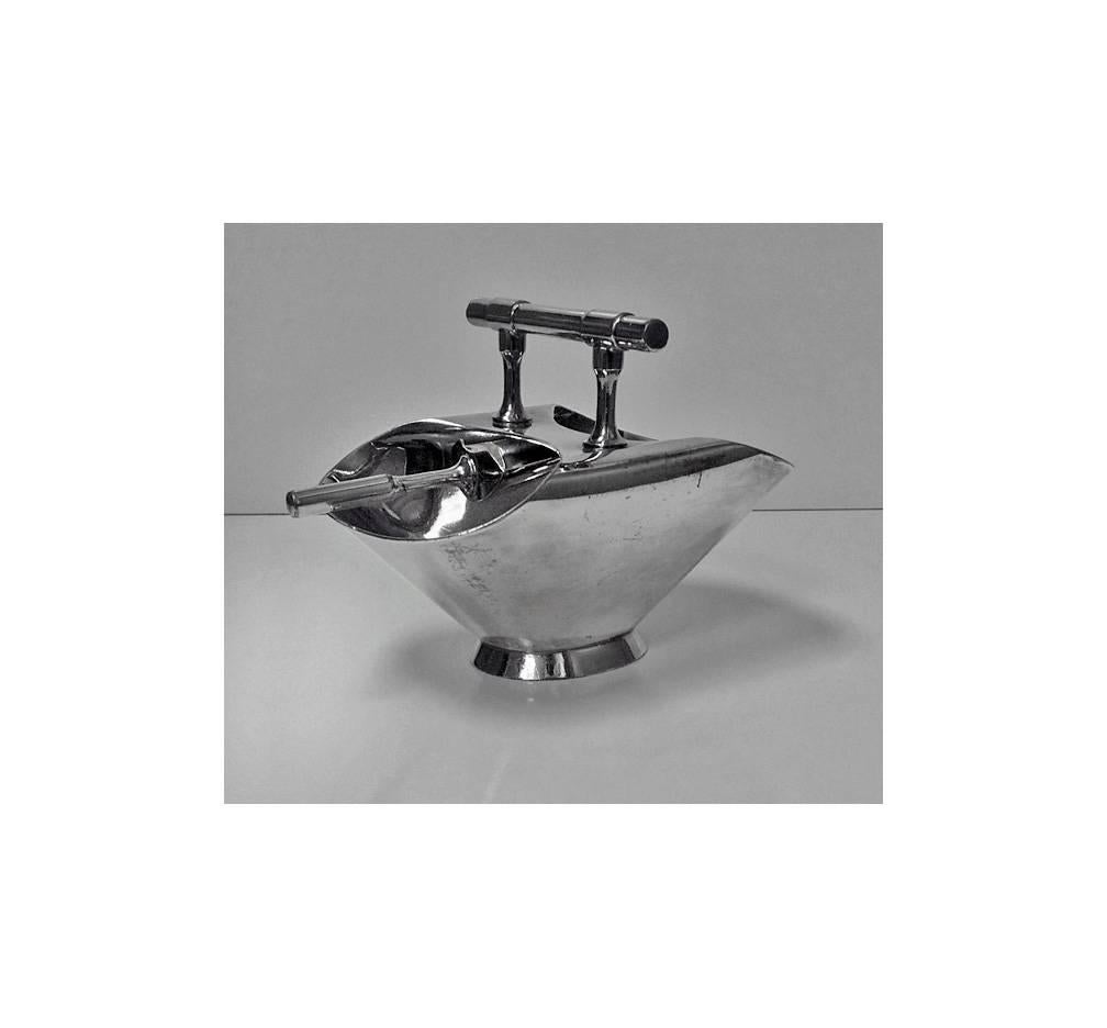 Christopher Dresser designed silver plate double ended Sugar Scuttle, with spoon. England C.1900, Walker & Hall. The Sugar scuttle, plain oval slightly spreading footed base, with central plain handle . Stamped on the underside 998 Walker & Hall