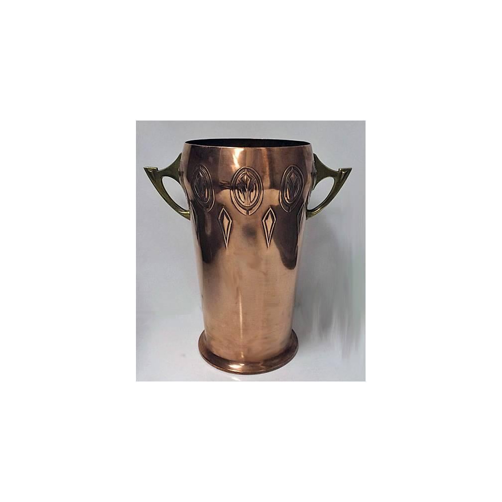 W.M.F Art Nouveau Jugendstil Wine Cooler, Germany C.1900. The Wine Cooler of large size, the copper body slightly tapered cylindrical form, the top decorated with art nouveau jugendstil panel surround, the brass handles of open art nouveau stylised