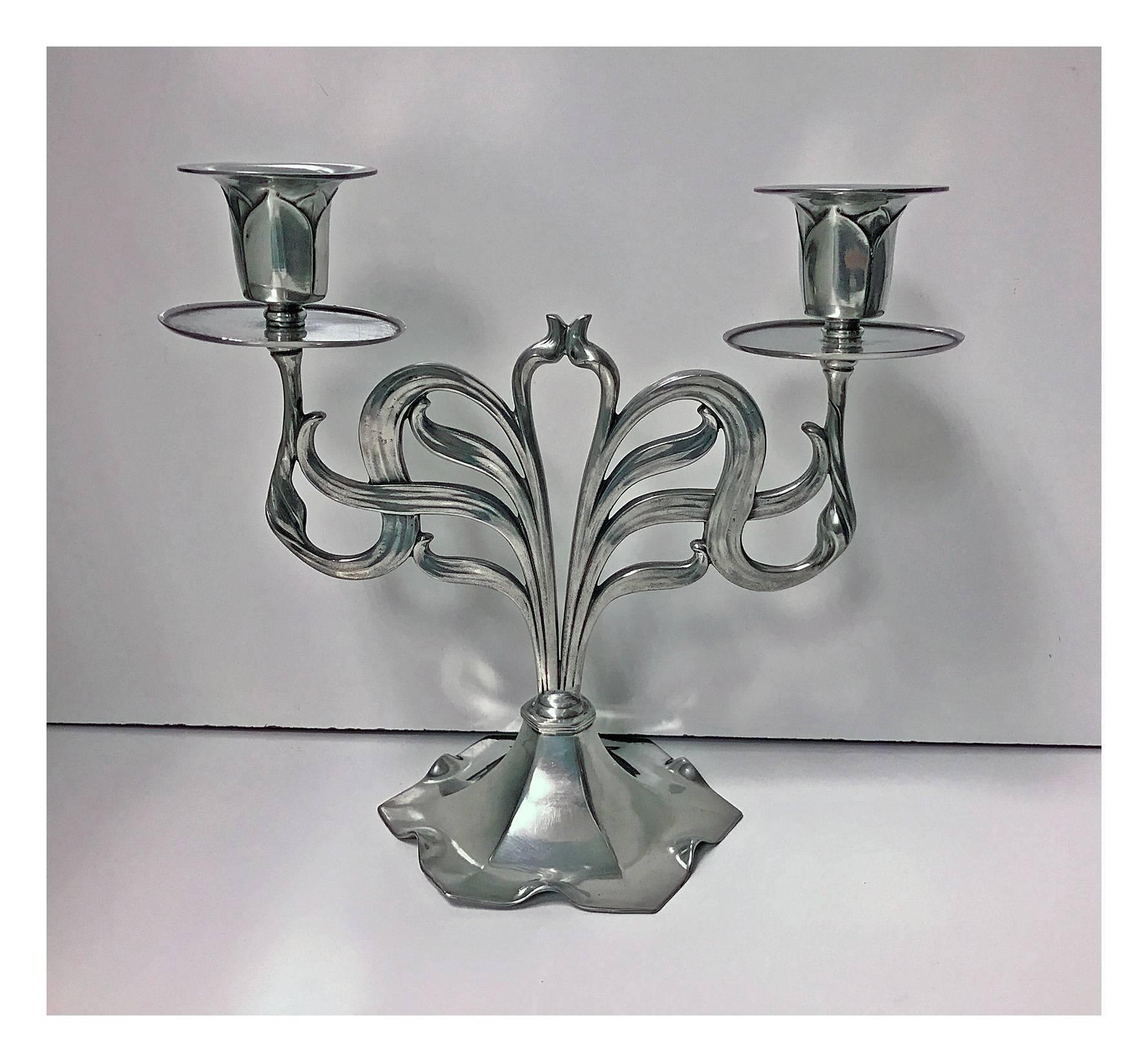 Orivit Jugendstil Secessionist Art Nouveau candelabra, Germany, circa 1900. The polished pewter candelabra each on crimped hexagonal base, supporting open stylised flowing organic foliate centres with detachable screw bobeche and sockets conforming