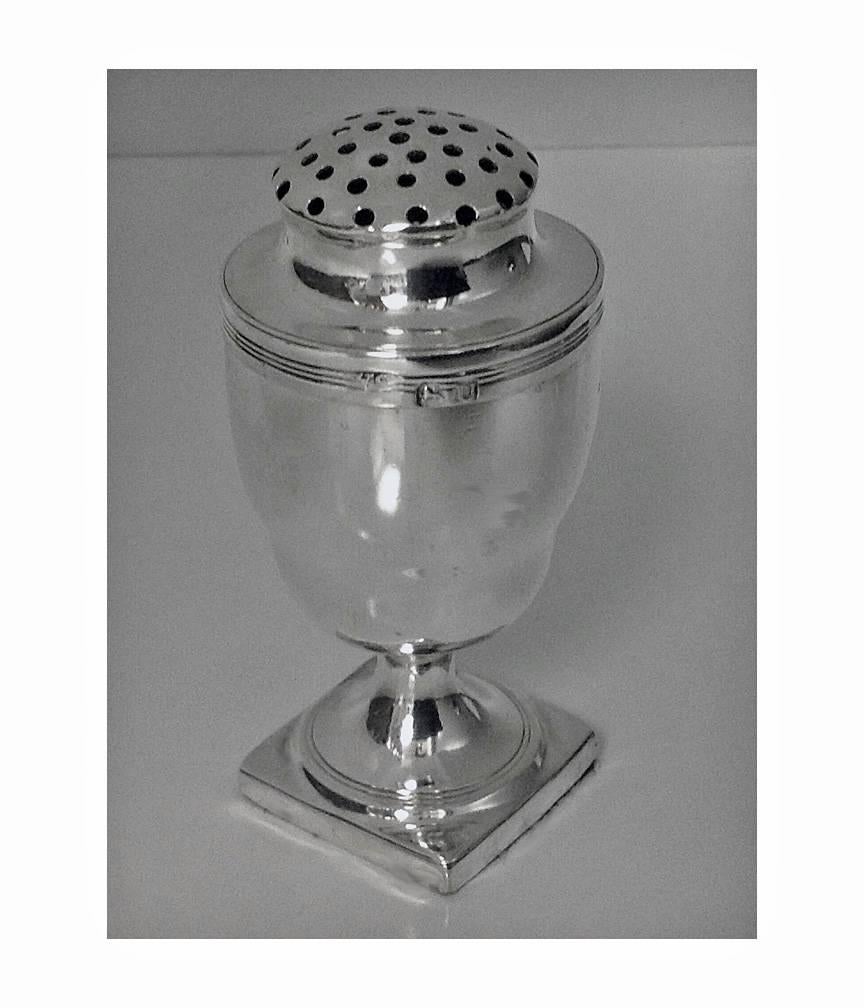 Georgian Silver Pounce Pot, London 1815, Stephen Adams. The pot of nutmeg shape, square pedestal base, removeable reed border pierced cover, gilded interior. Marked on body and cover. Height: 3.25 inches. Item Weight: 90.76 grams.