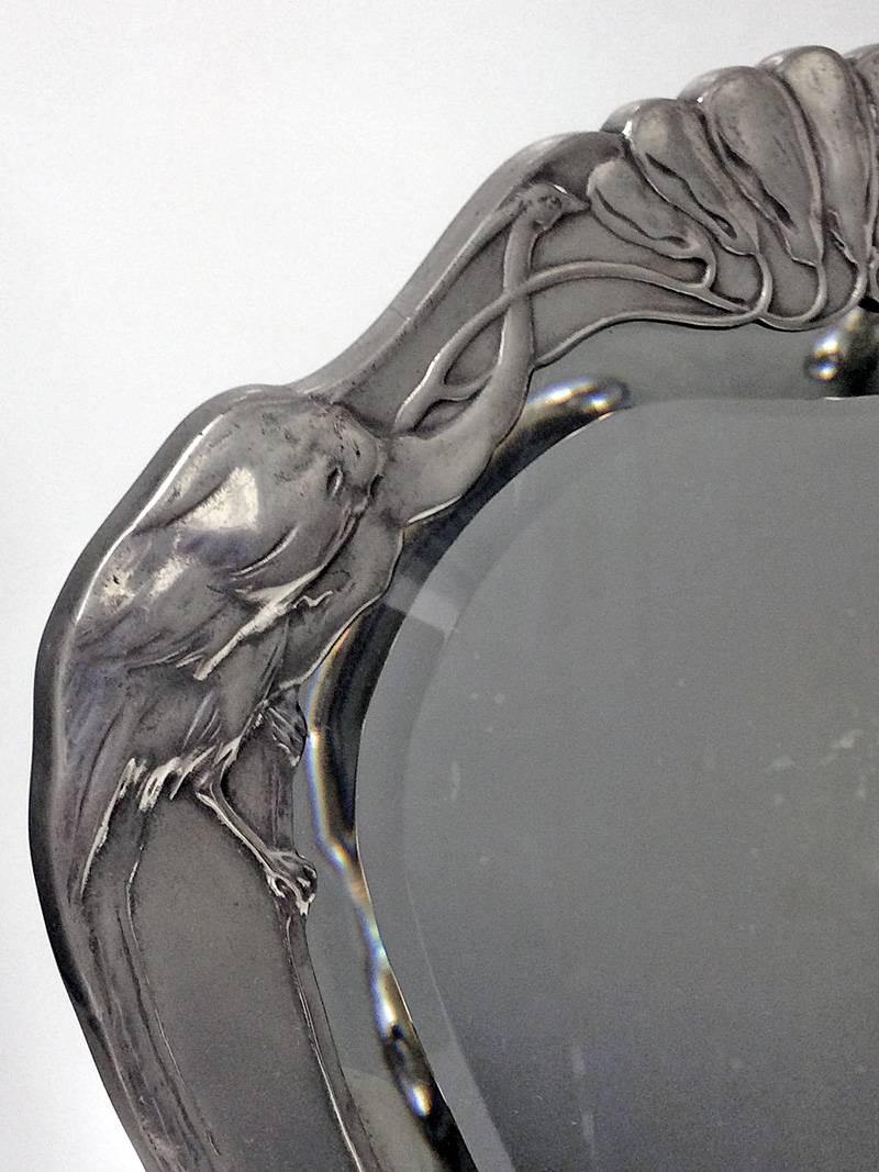 Art Nouveau Jugendstil pewter mirror designed by Friedrich Adler for Osiris, Germany, circa 1901. The mirror with surround of two peacocks. Stamped on reverse Osiris 521 height: 12 inches. Illustrated P172 Friedrich Adler zwischen Jugendstil under