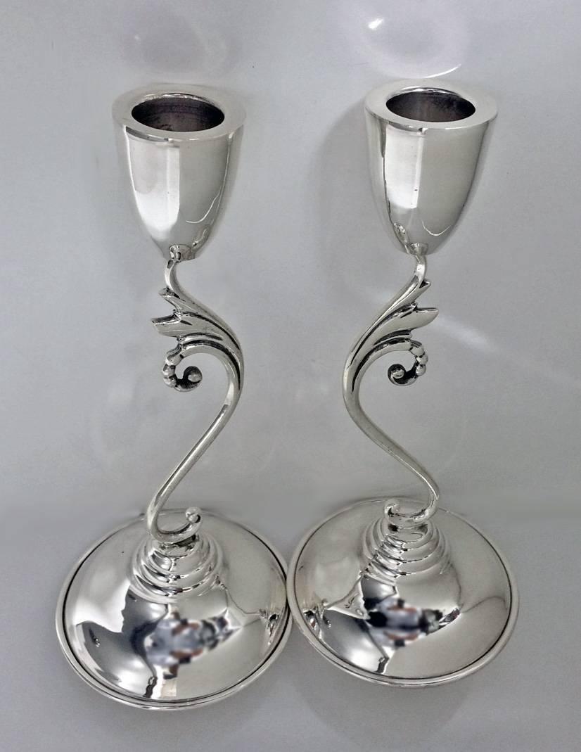 Pair of Mid-Century sterling silver candlesticks, Mexico, circa 1960 by Perlita. Each on dome base, central scroll stem supporting plain tapered sconce. Stamped on underside for Perlita and eagle 1 mark. Height: 8.75 inches. Weight: 372.55 grams.