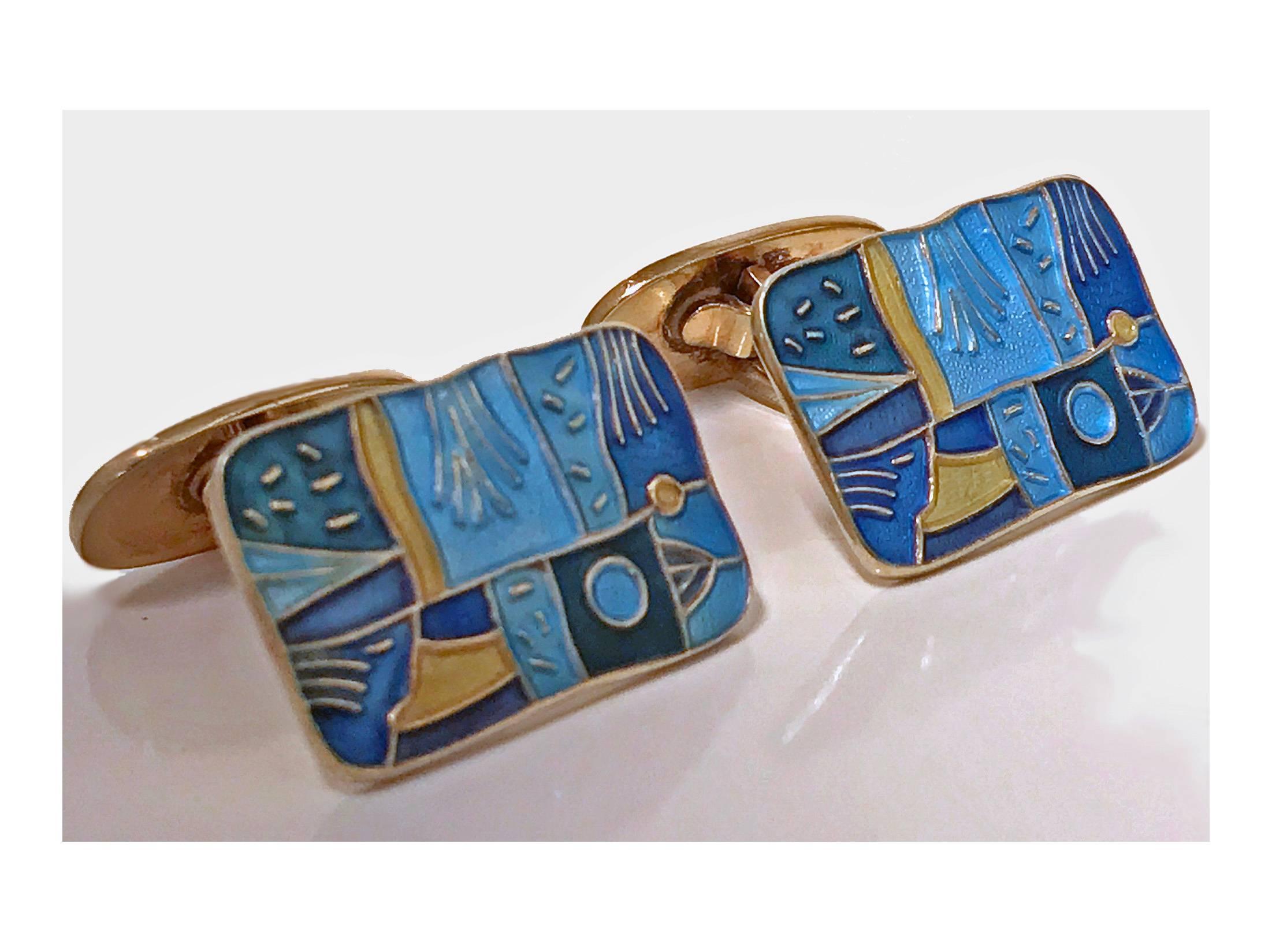 Pair of enamel and sterling silver with vermeil finish Spring' cufflinks, Oslo, Norway, circa 1959, David Andersen. The cufflinks of rectangular shaped form inlaid with a varied blue and gold enamel colors of an art style. Hinged oval back. Fully
