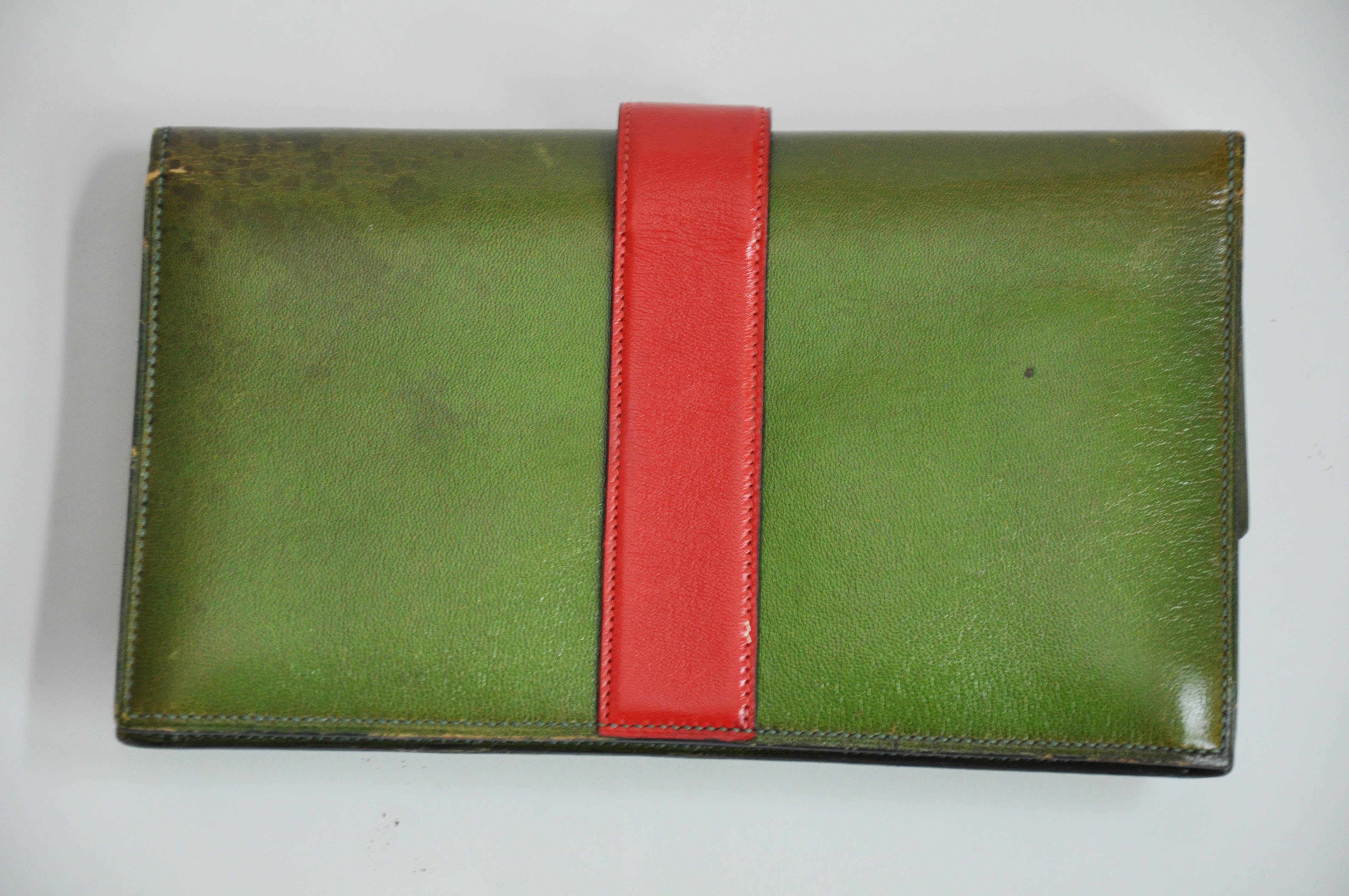 A rare vintage Hermès Medor clutch purse, in unique apple green leather with red leather clasp and brass studs.