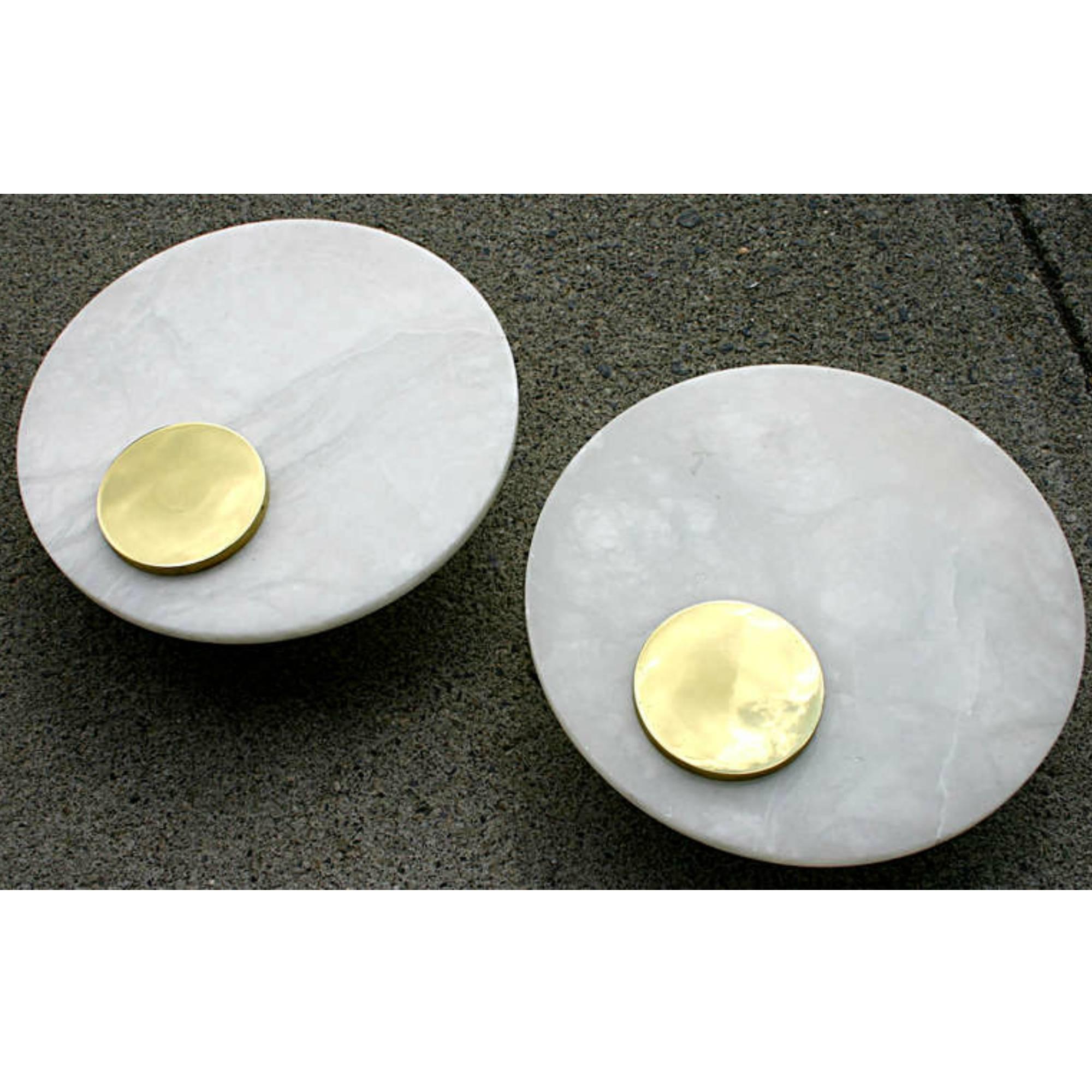 Simple and elegant pair of alabaster floating disc sconces.
