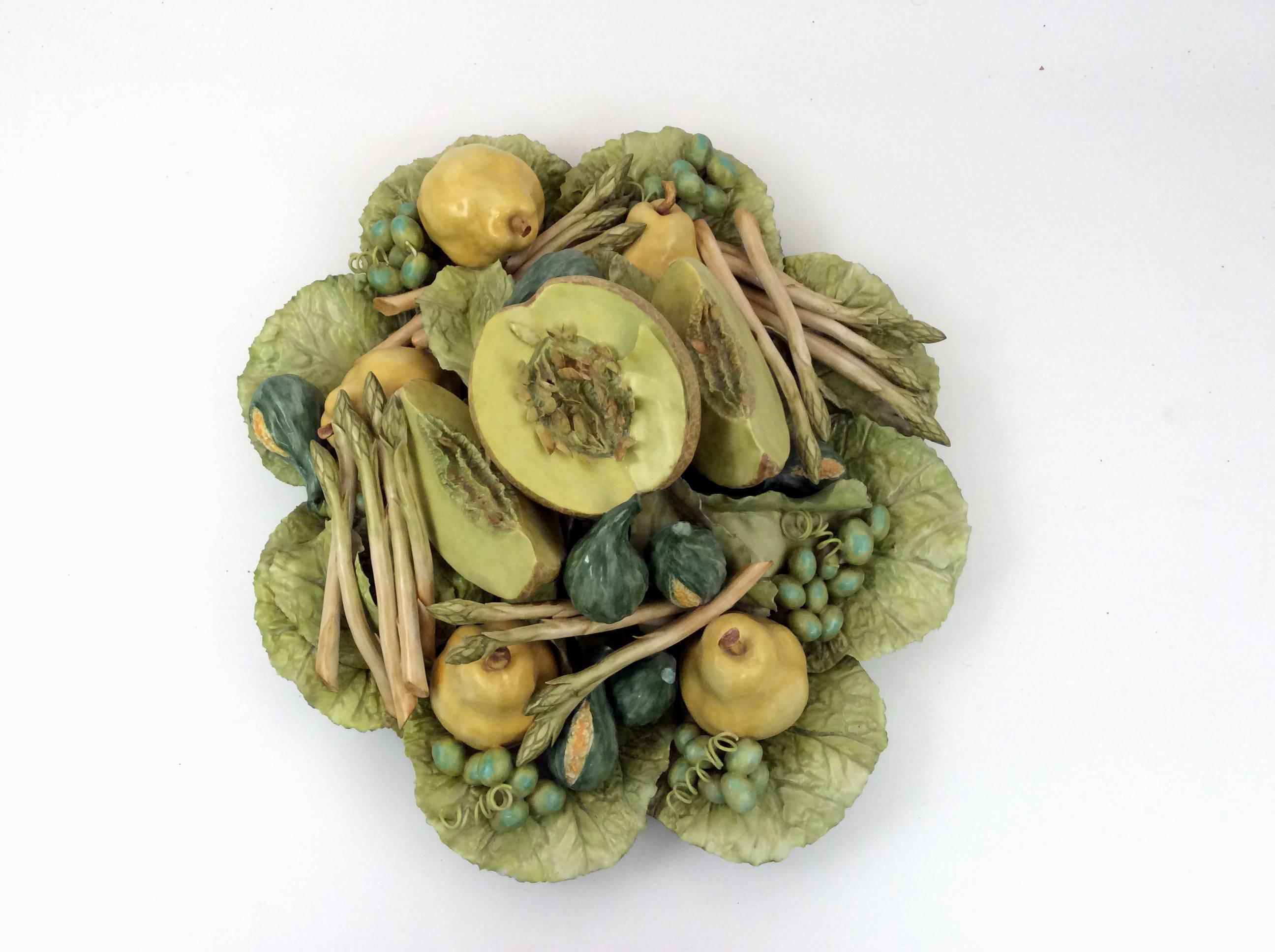 This is a large centerpiece with a central honeydew surrounded by figs, pears, grapes, and asparagus in a bowl of leaves all in a variety of soft green and yellow hues. this is a one of a kind handcrafted piece.
Katherine Houston is a living artist
