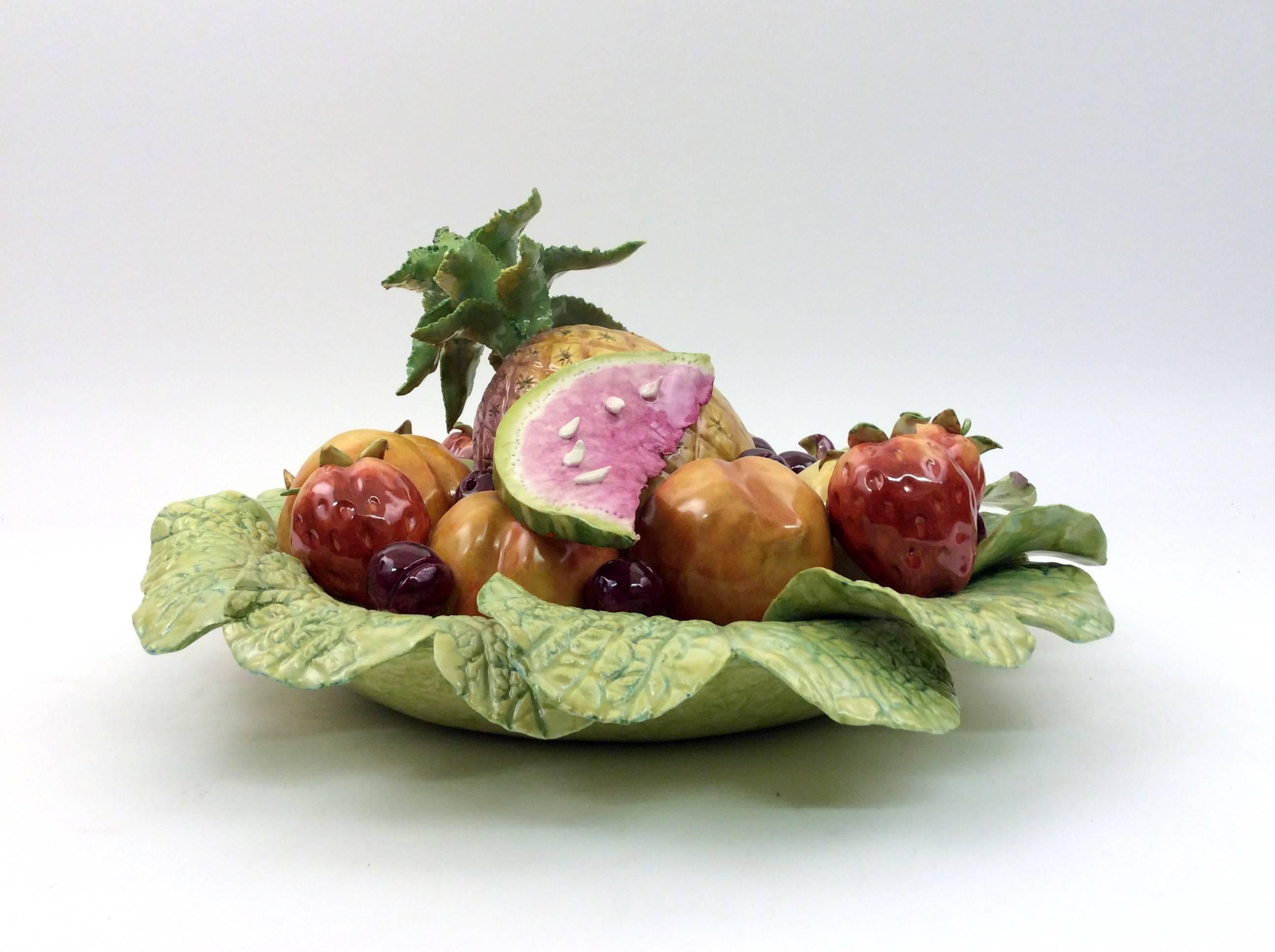 This centerpiece features a cabbage leaf bowl holding richly colored peaches, cherries, strawberries, figs and lemons topped with thinly sliced watermelon and a petite pineapple. This is a one of a kind hand crafted piece.
Katherine Houston is a