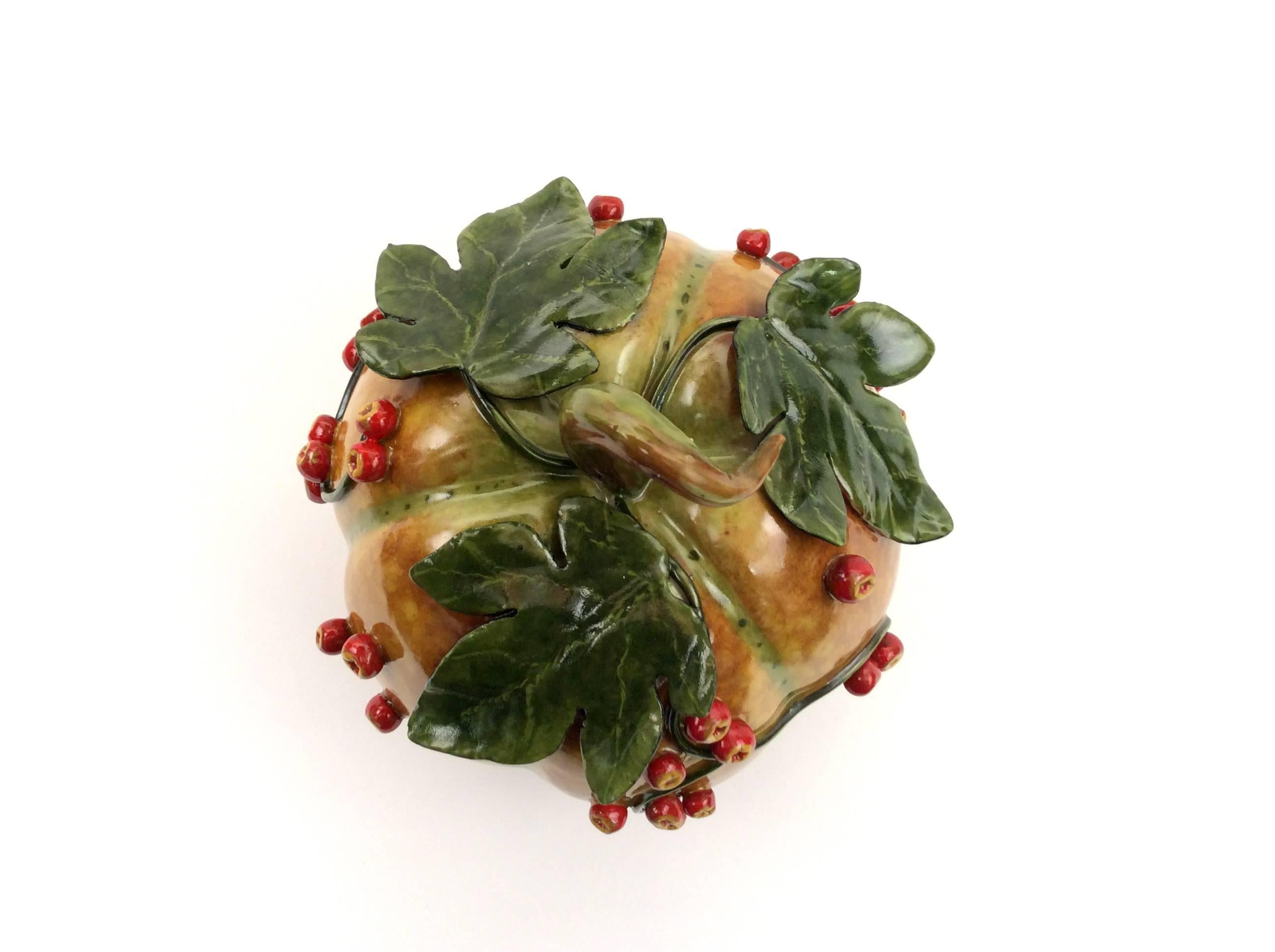 This small melon in rich amber hues is adorned in leaves, vines and bittersweet berries. A wonderful piece for a display cabinet, small table or any room need a moment of warmth. This is a one of a kind handcrafted piece.
Katherine Houston is a
