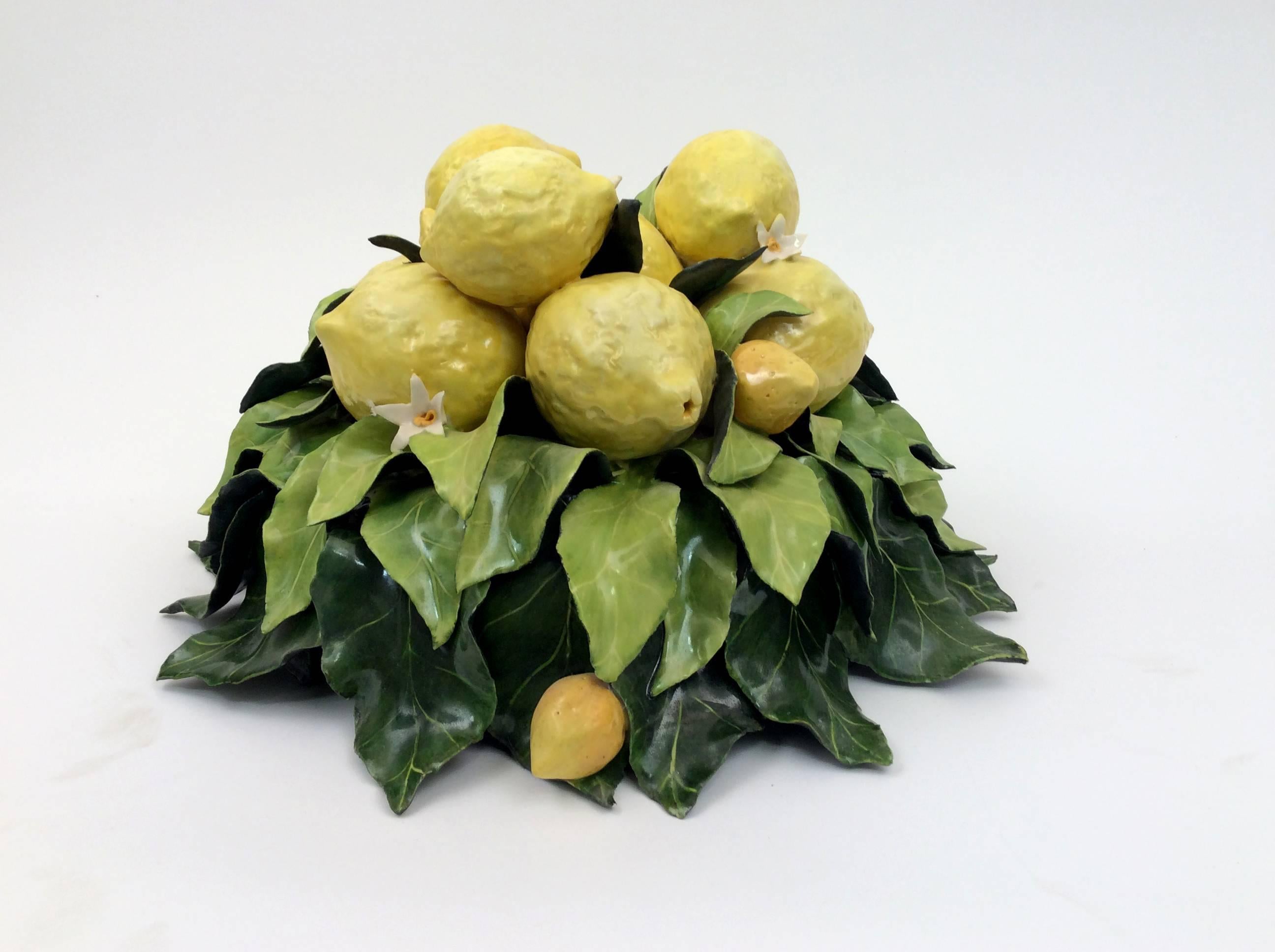 A raised bowl of leaves cradling a collection of lemons, embellished with kumquats and blossoms. this is a one of a kind handcrafted piece. 
Katherine Houston is a living artist working in an 18th century technique, adapting the techniques and