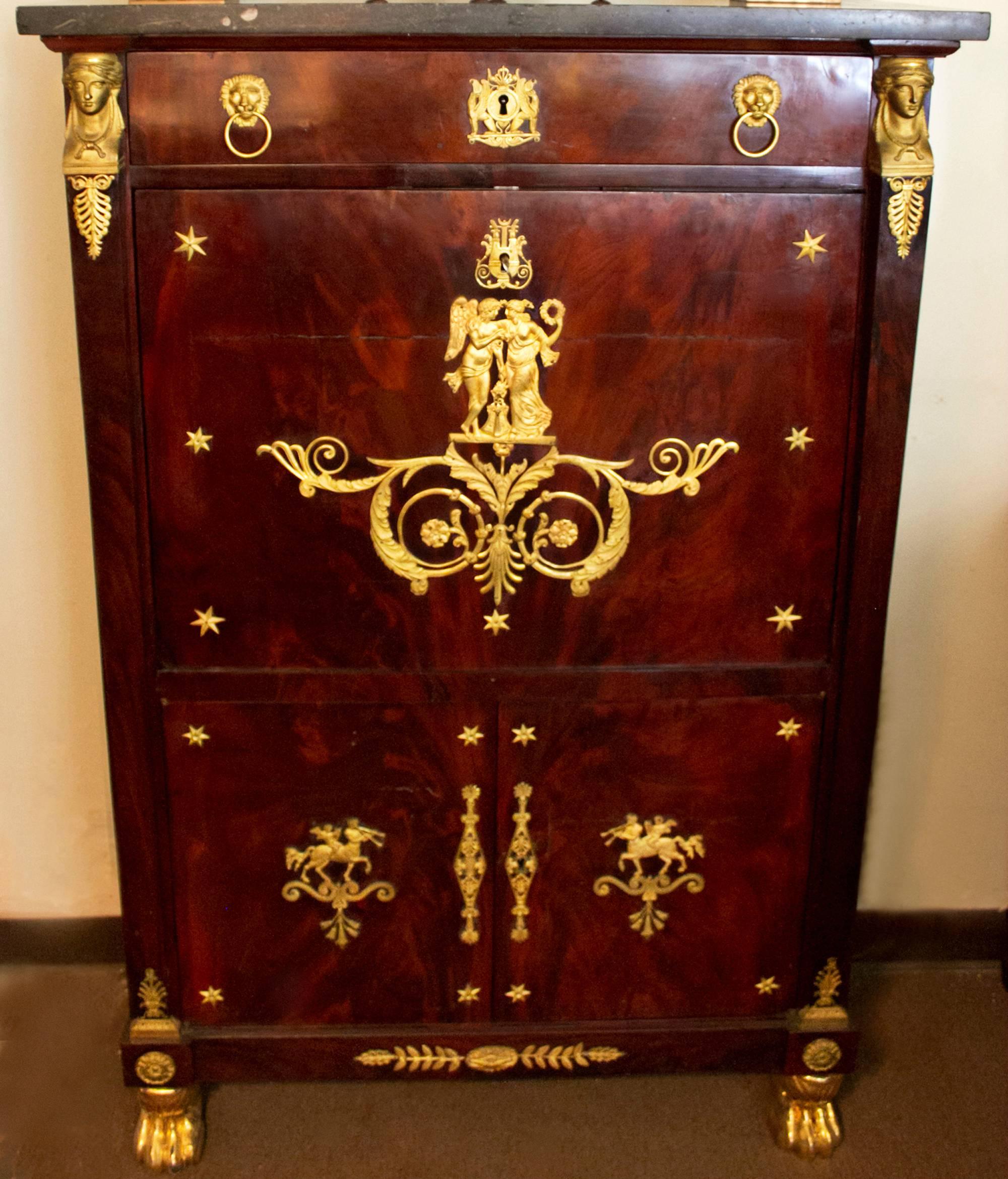  French Second Empire period flame mahogany and gilt brass-mounted secre´taire a' abattant retaining its original dark grey speckled granite top. Decorated throughout with the original ormolu neoclassical motif, the facade framed by caryatid-shaped