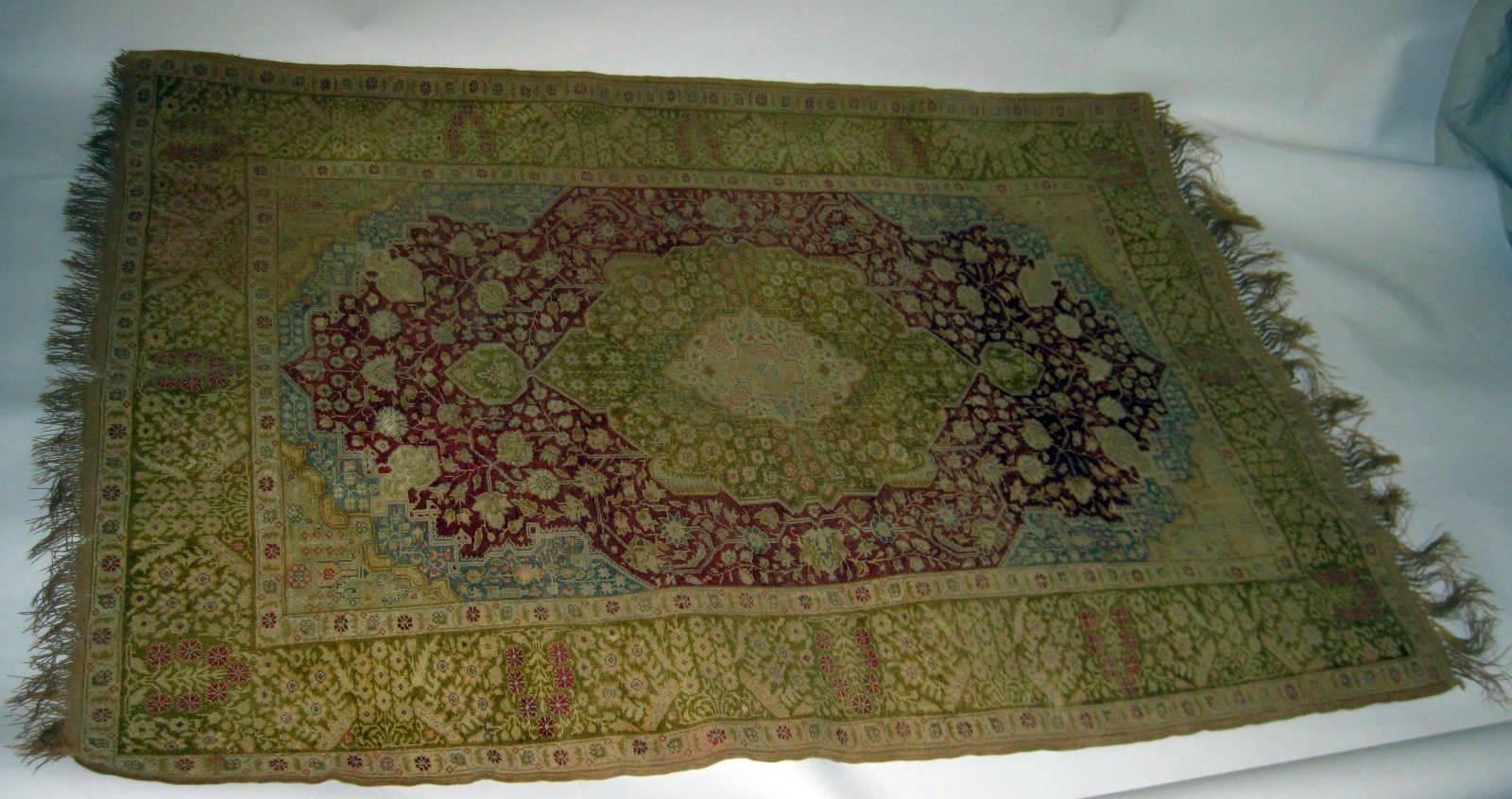 Rare silk Sivas, circa 1870-80. Silk pile on a cotton foundation featuring a delicate combination of floral and geometric designs with a cream center medallion with a small rosette on a rusty red field set inside a secondary green medallion with