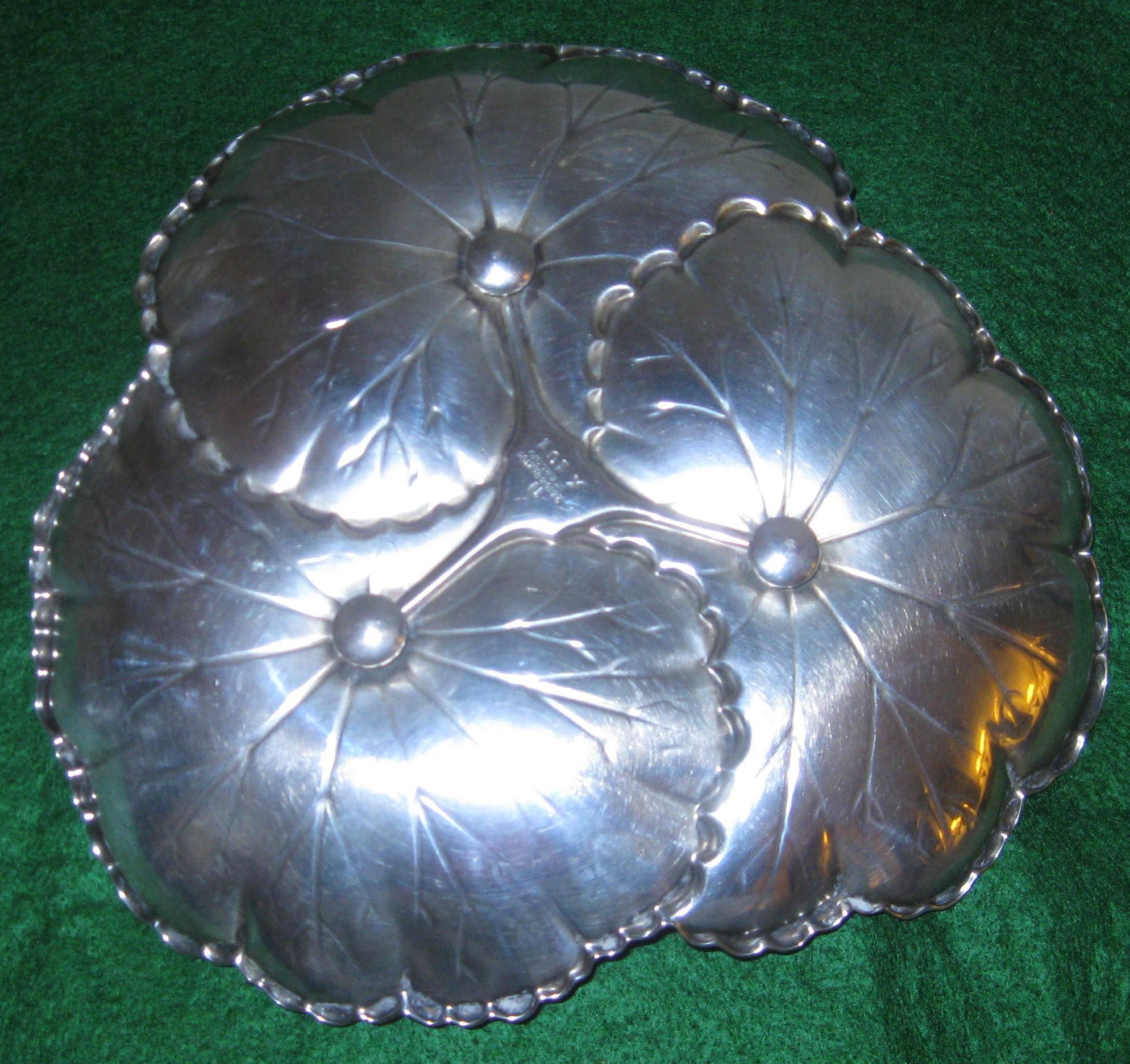 Sterling silver tray in the Art Nouveau style featuring three lily pads. It is marked Reed and Barton X101.