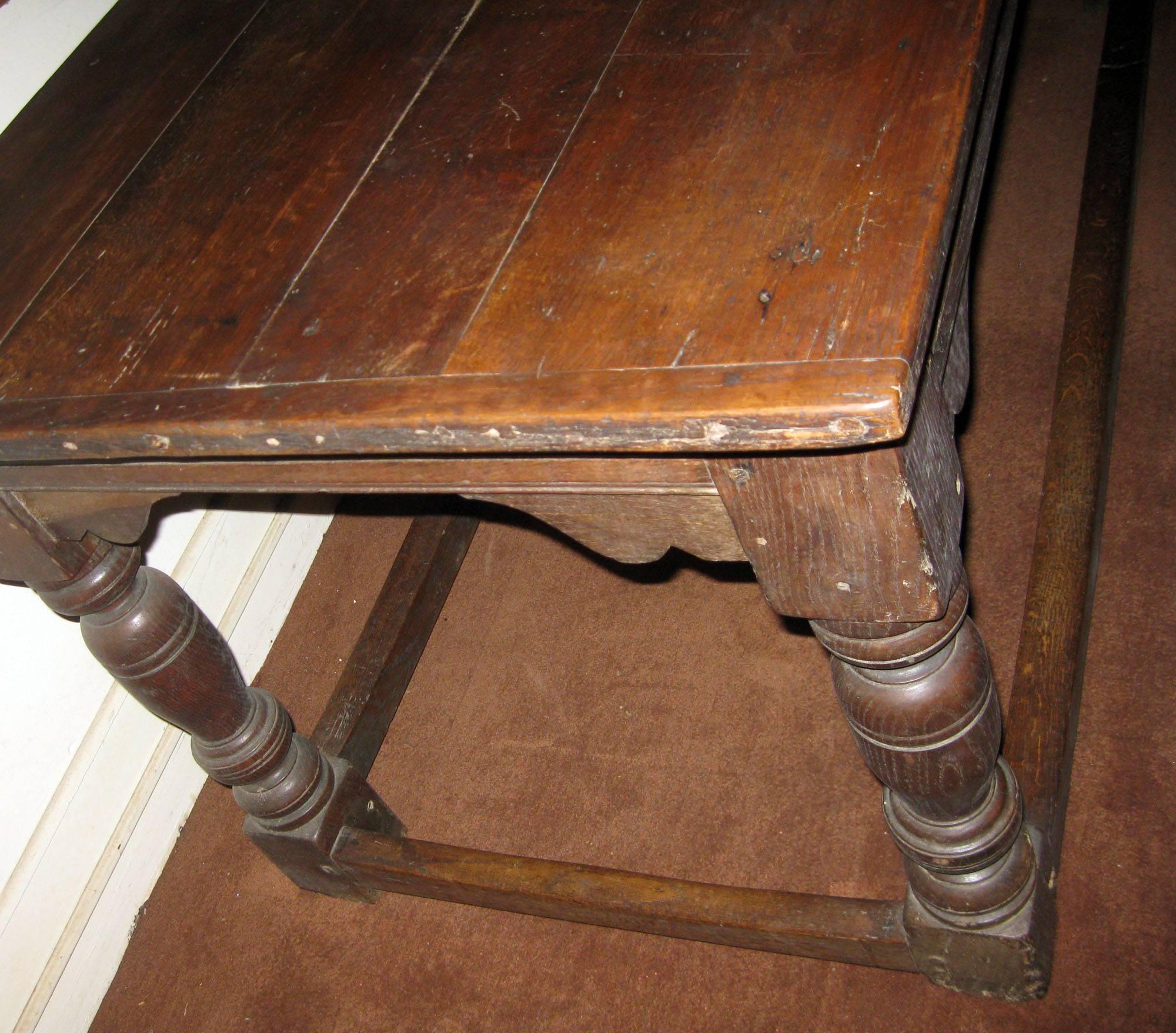 English oak refectory table with balustrade turned legs and stretcher base. Original finish with great patina. Maintains all the scratches, notches and wear of almost 350 years. See measurements below.