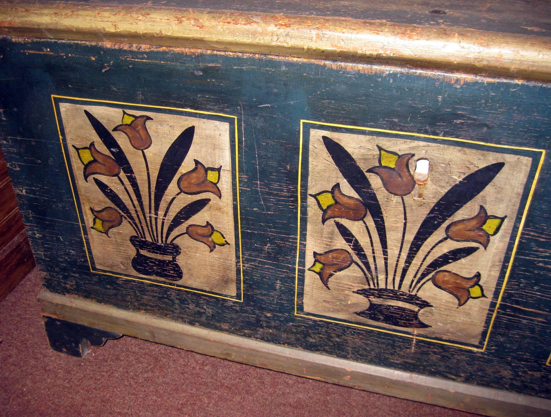 American Folk Art stenciled pine Pennsylvania Dutch blanket chest with original paint. On the top the paint is faded and a bit worn but the front and sides are strong with decorative vases of graceful tulips. Bracket feet. Original hand-wrought