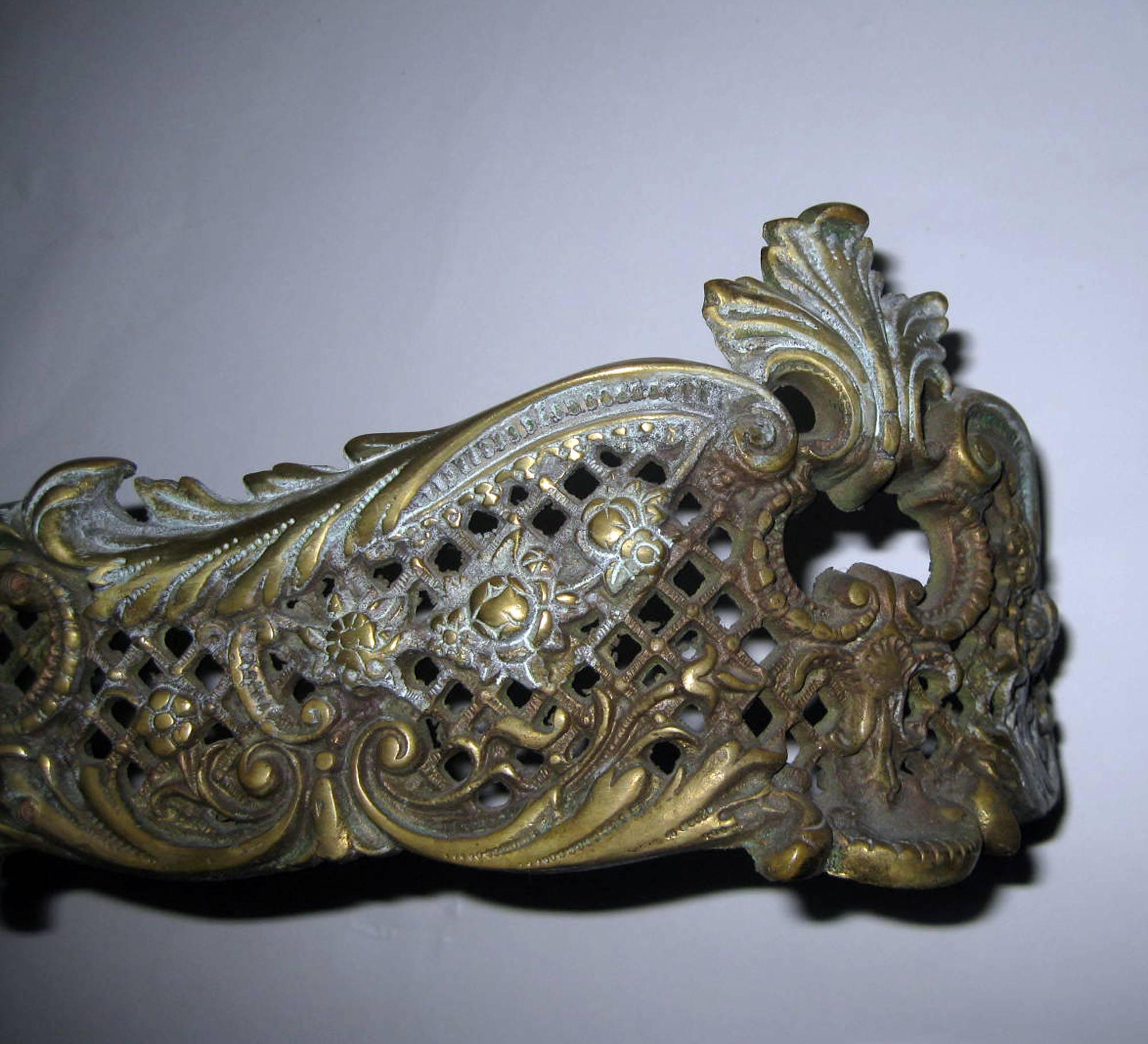 Very ornate bronze fireplace fender in the Rococo style. Lots of detail.