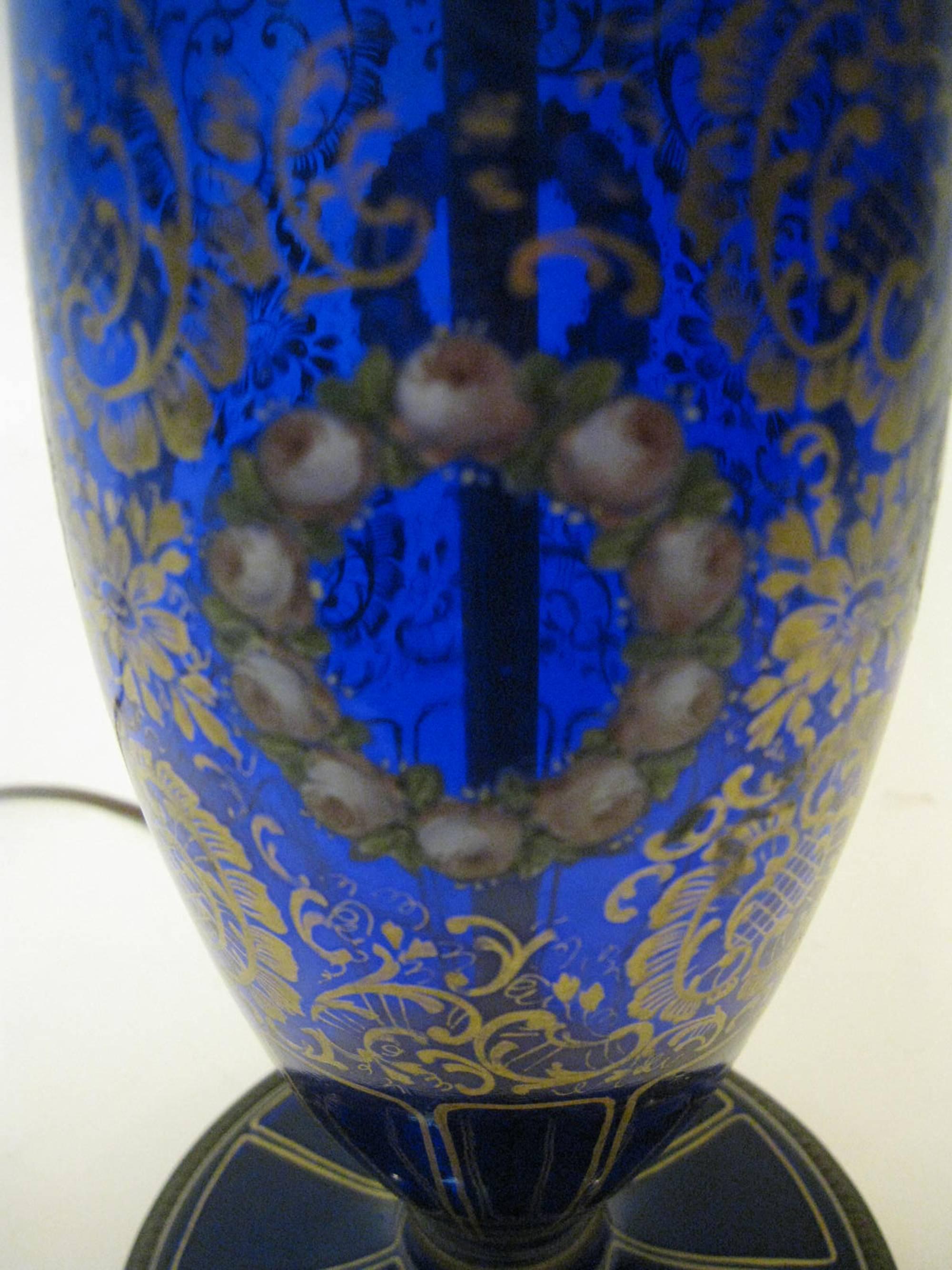 Bohemian cobalt blue Moser Art glass lamp featuring elaborate decoration with hand-painted flowers and raised white beading. The decoration is ornate and elegant and features delicate wreaths of pink rose, gold filigree and enamel dot highlights.