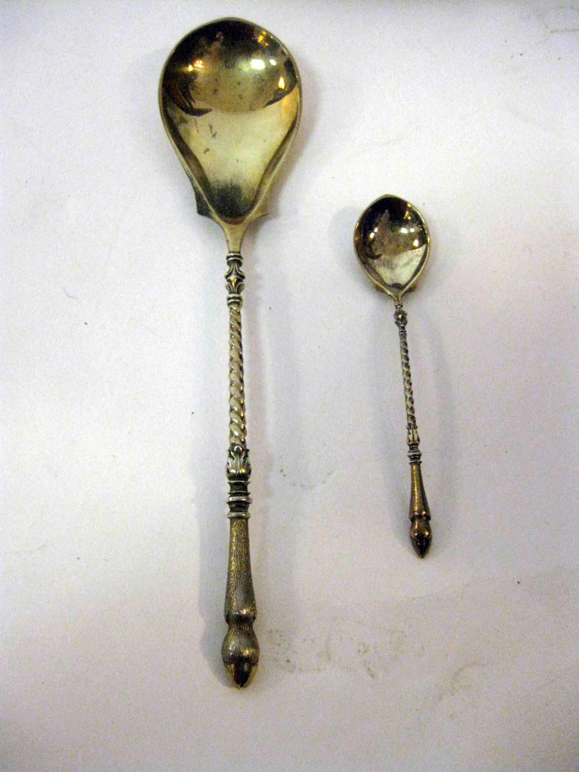 Serving set consisting of one large and eighteen small spoons. The large spoon is marked Humbert & Sohn with I 800 and a crescent moon, the smaller spoons I 800.  Jean Georges Humbert & Sohn Georges 1802-1863 was located in Berlin,and was jeweler to