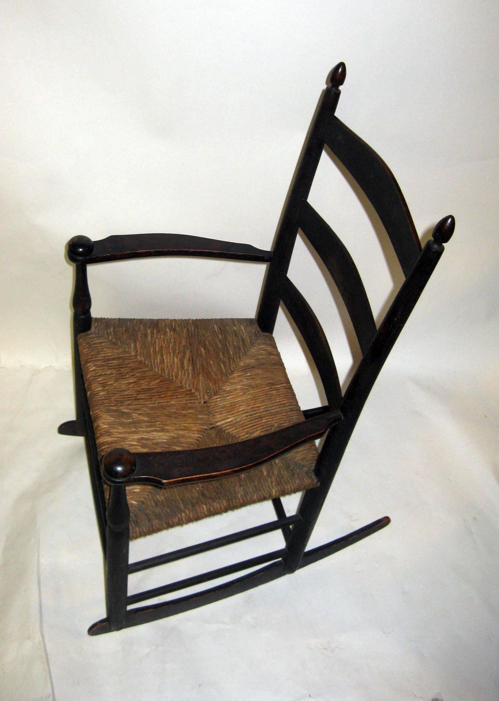 Antique child's maple rocker with arms marked 
