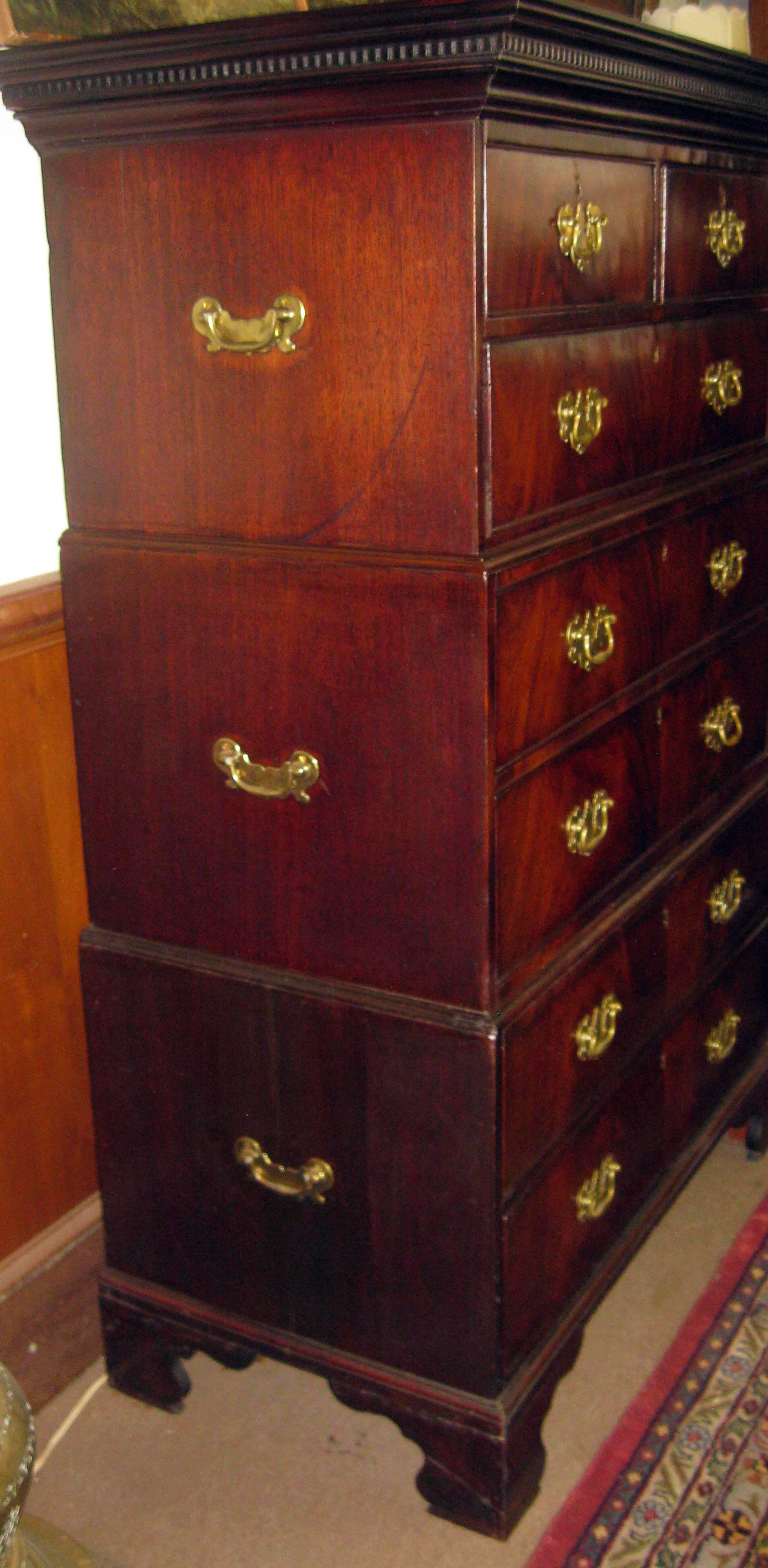 Rare tree part chest on chest with brass carrying handles on sides used for easy transport when travelling. Crown features dental detail. Bracket feet. Original brasses. Seven drawers. Mahogany principle wood, oak secondary. Original finish. There