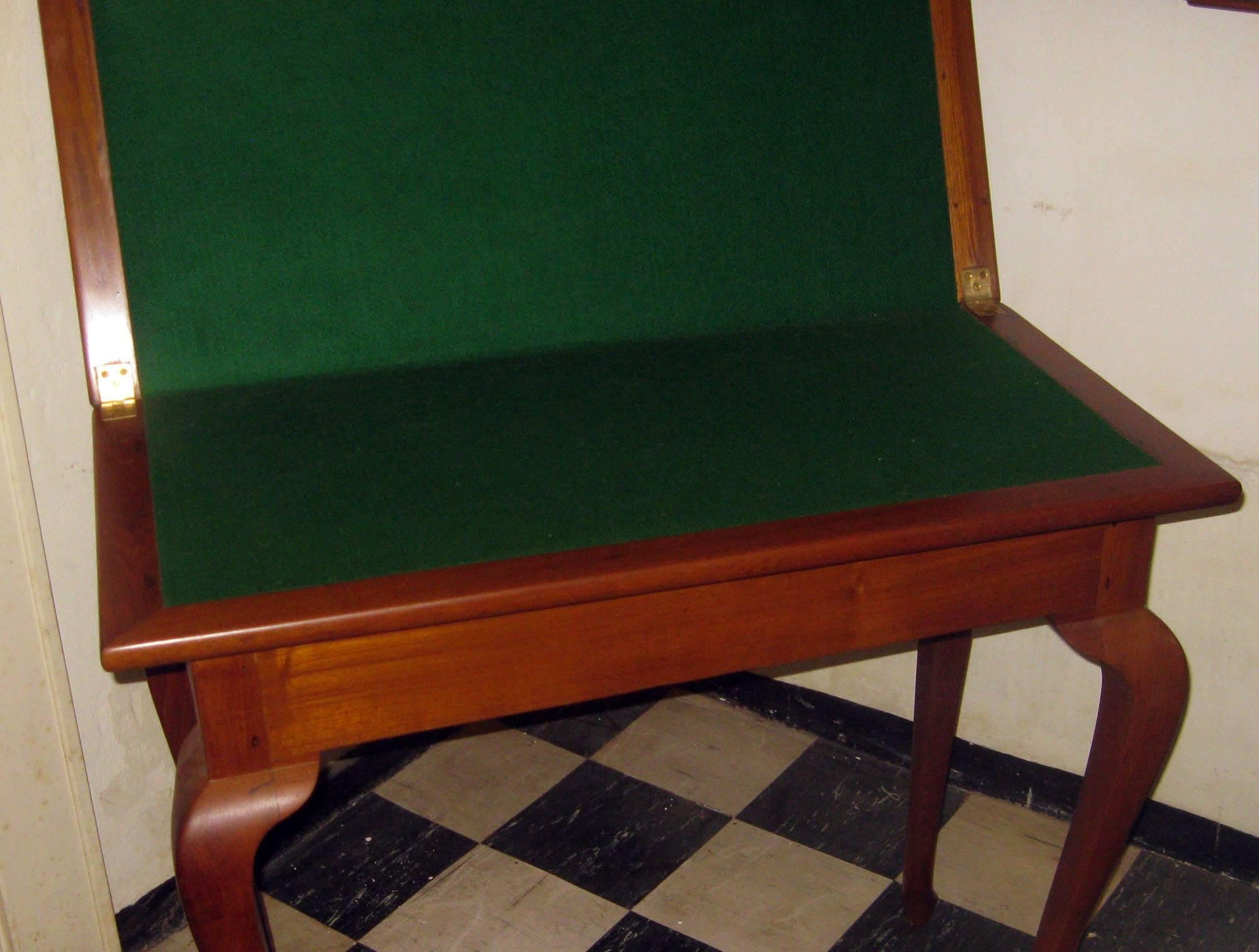 Anglo Indian hardwood card table featuring graceful Queen Ann style legs ending in diminutive pad feet. Working drawer on end with faux drawer on opposite end. Simple and elegant. Please note some of the closeup photos look a little 