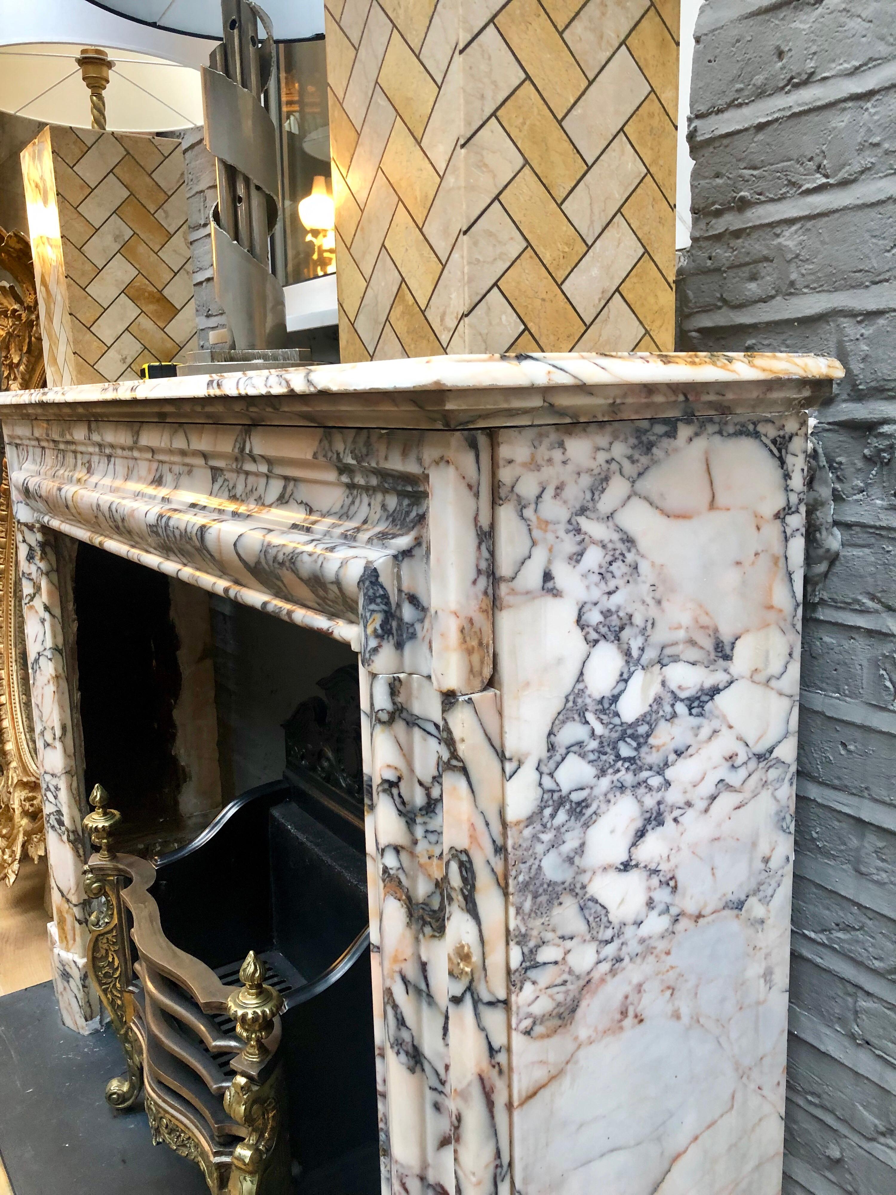 An antique Bolection moulding fireplace in rare Breche Violette marble, with a stepped and moulded shelf. 

Opening size 99cm wide x 88cm high.