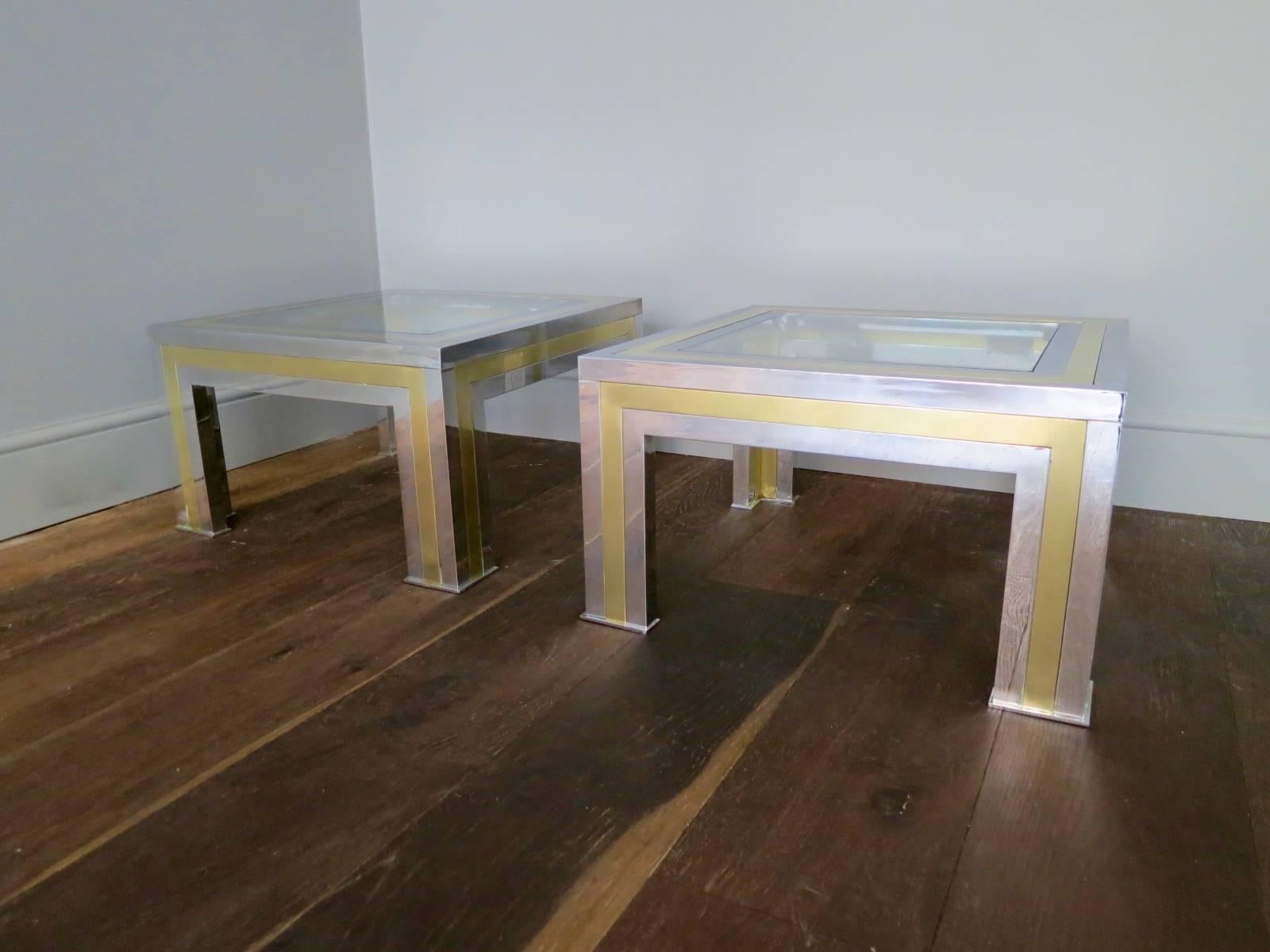 A pair of heavy and substantial good quality end tables in brass and chrome, retaining original glass. In the manner of Paul Evans City Scape range. Matching coffee table in separate listing.

French, circa 1970s.

Measures: 60cm x 60cm x 35cm.