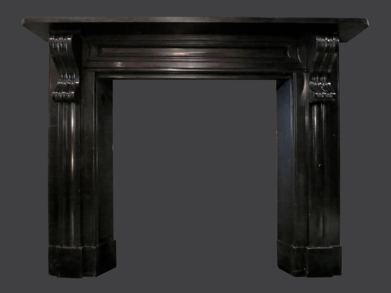 A large sophisticated mantel in black Kilkenny marble. From Rathvilly, County Carlow. The jambs with moulded panels and large deeply carved Irish Corbels, supported on separate foot blocks. The inverted inner slips being deeper than the outside