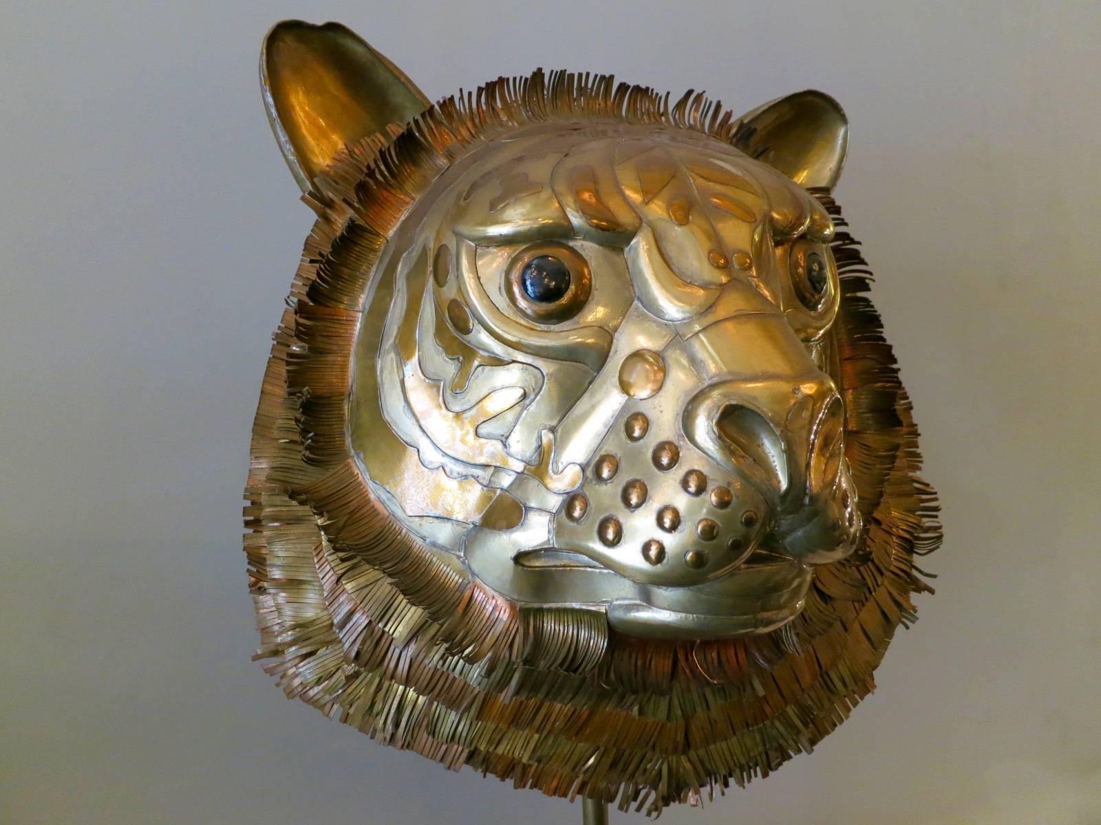 A large regal tigers head sculpture in brass, copper and tin by renowned Mexican artist Sergio Bustamante. Signed and numbered.