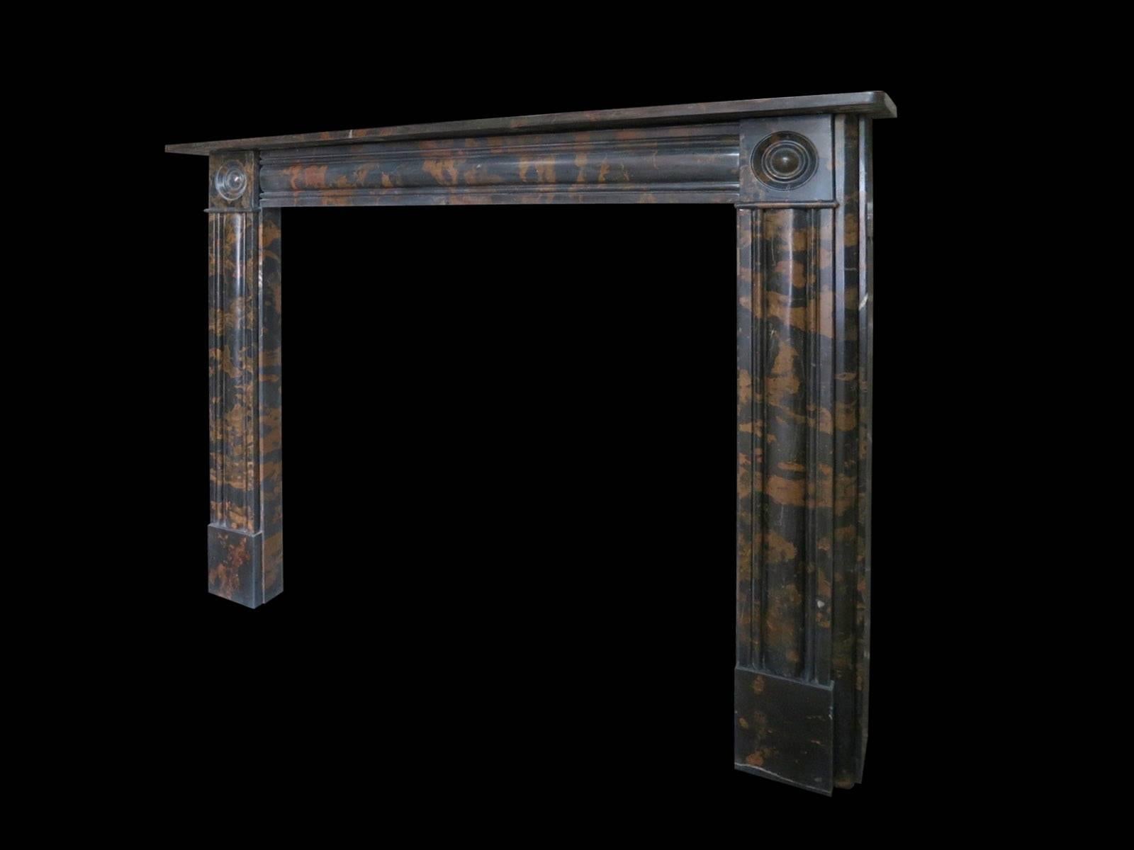 A reproduction early 19th century style mantel in a black and brown colored marble, with moulded panels to jambs and frieze. The corner blocks of carved roundels typical of that period, all beneath a simple mantel.
Measures:
97cm wide x 91cm high.
