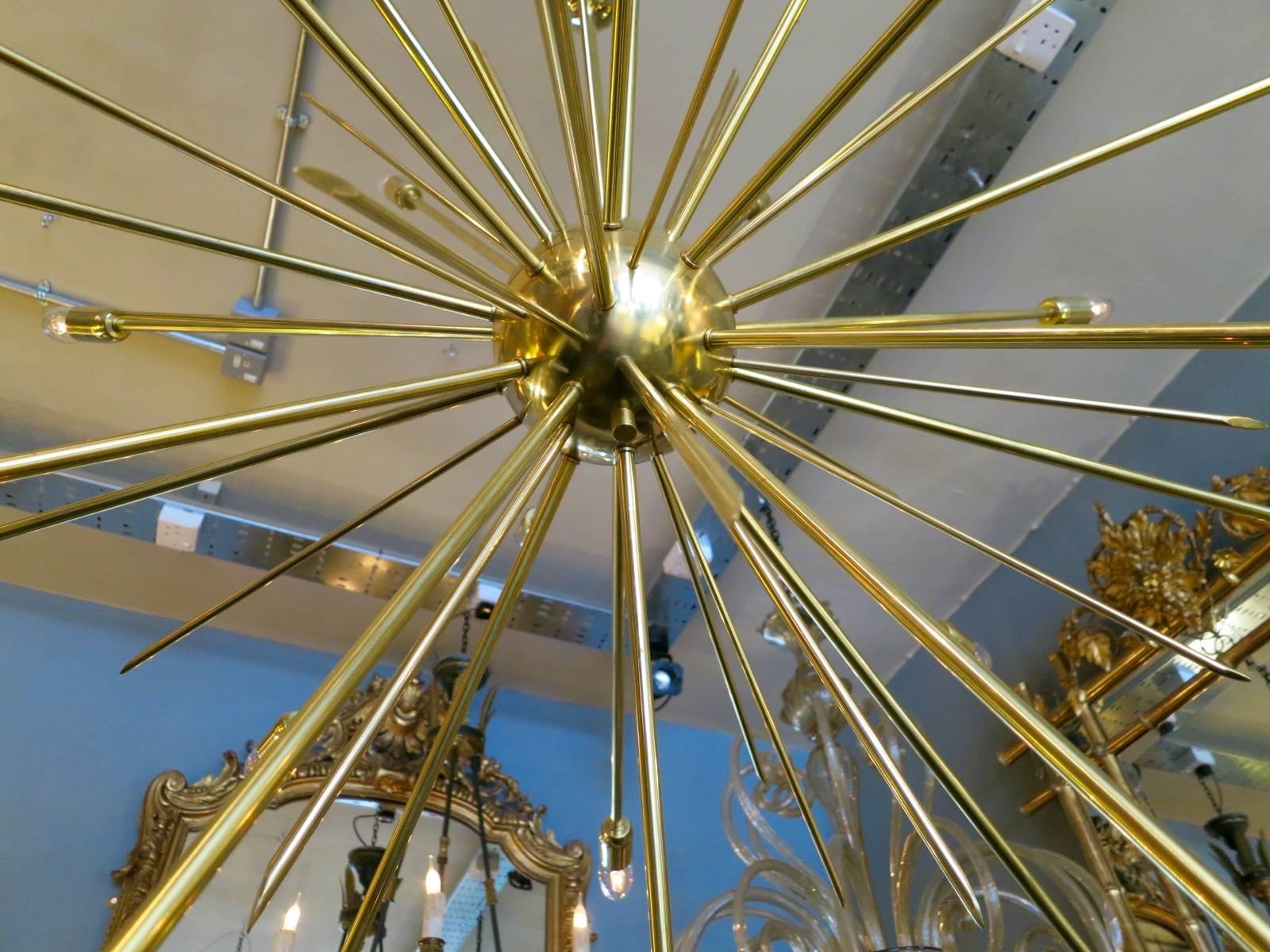 A contemporary very large 24 arm Sputnik chandelier completely in brass, with brass spiked centre. 
Italian in the manner of Mid-Century design by manufactures such as Stilnovo, Arteluce and Arredoluce etc.