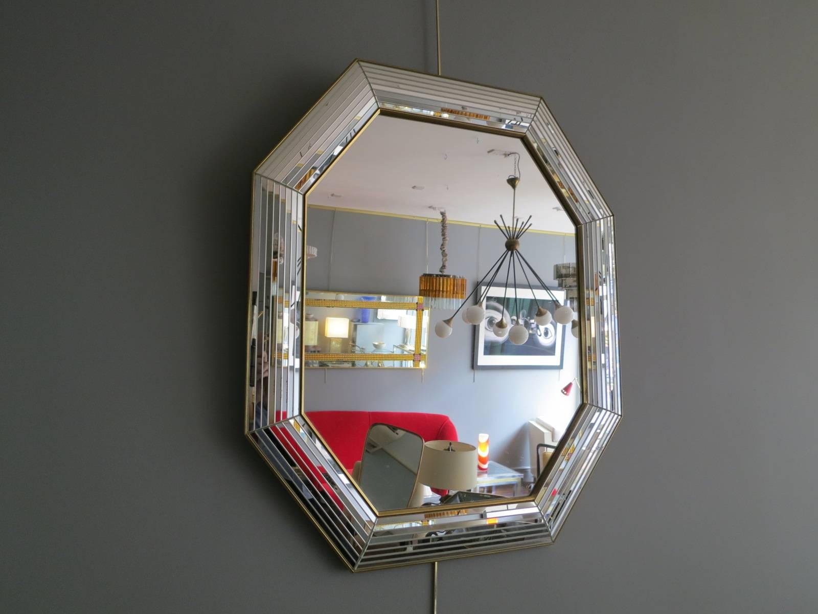 An octagonal gold gilt panelled mirror.