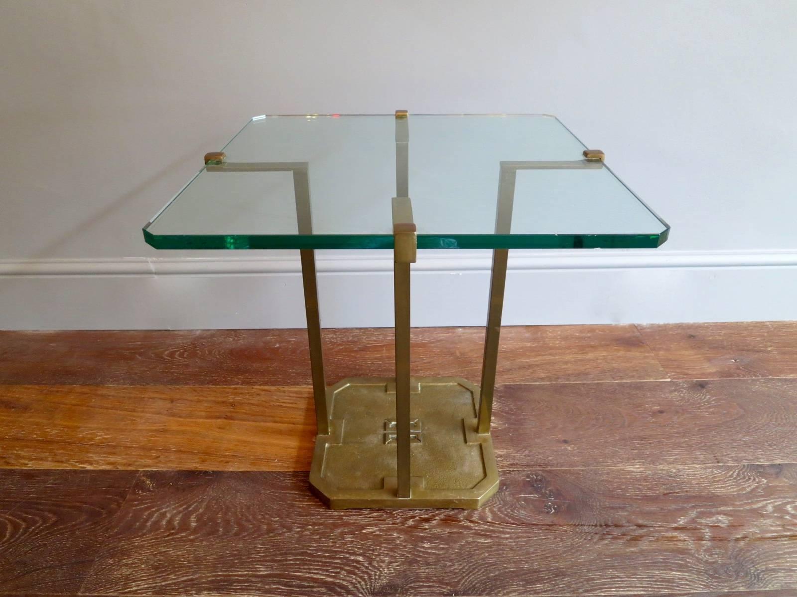 An architectural designed table, using quality materials with the Ghyczy emblem in the brass base and a thick glass shaped top.

