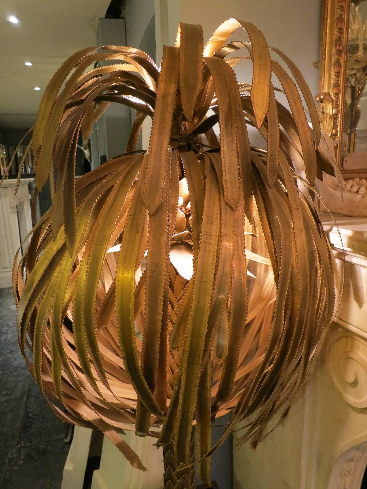 A large decorative floor lamp in brass, with brass trimmed black lacquered base by Maison Jansen, Paris.