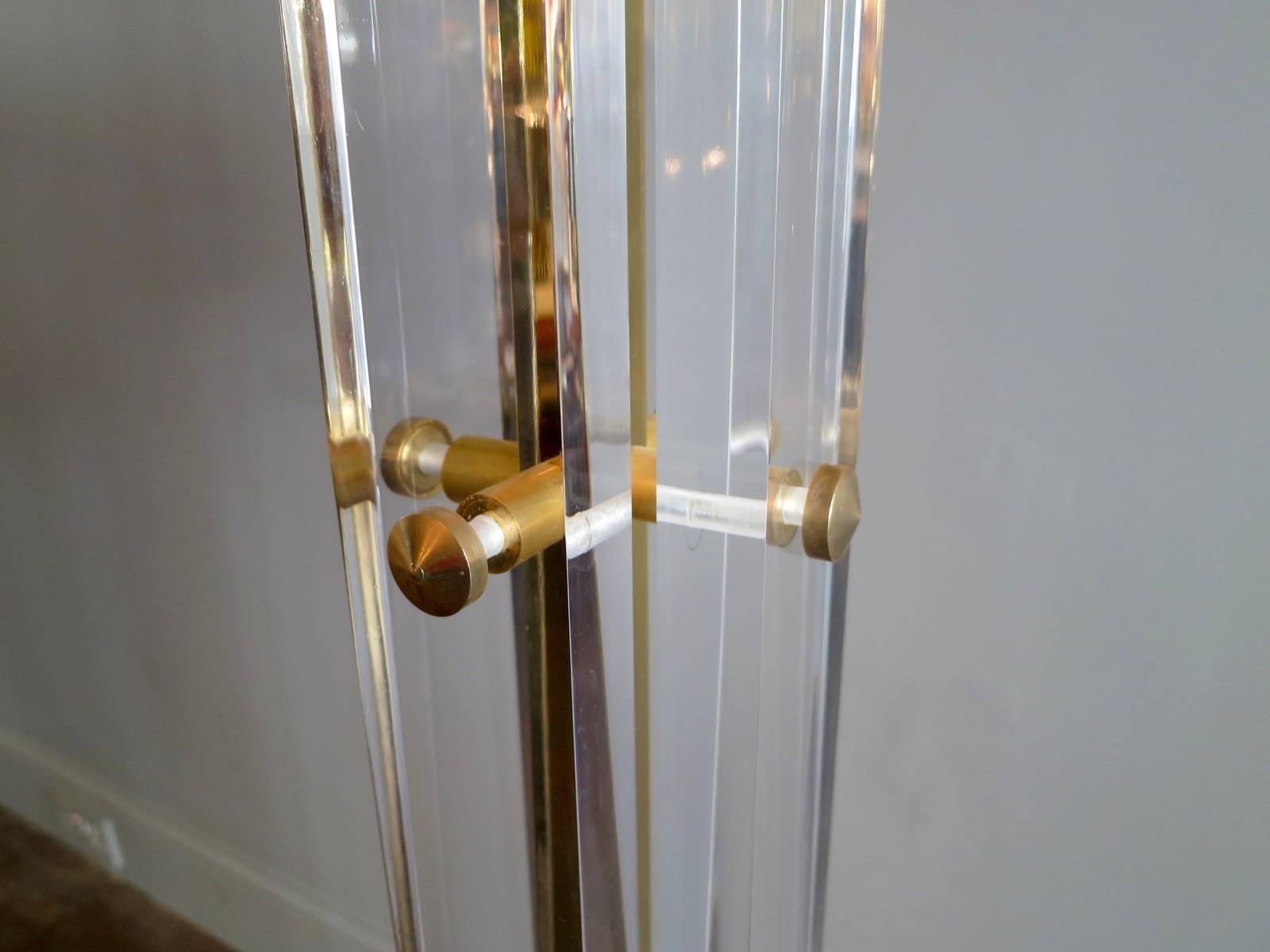 A very tall up lighter or torchere in gold plated brass and Lucite by Romeo Paris.