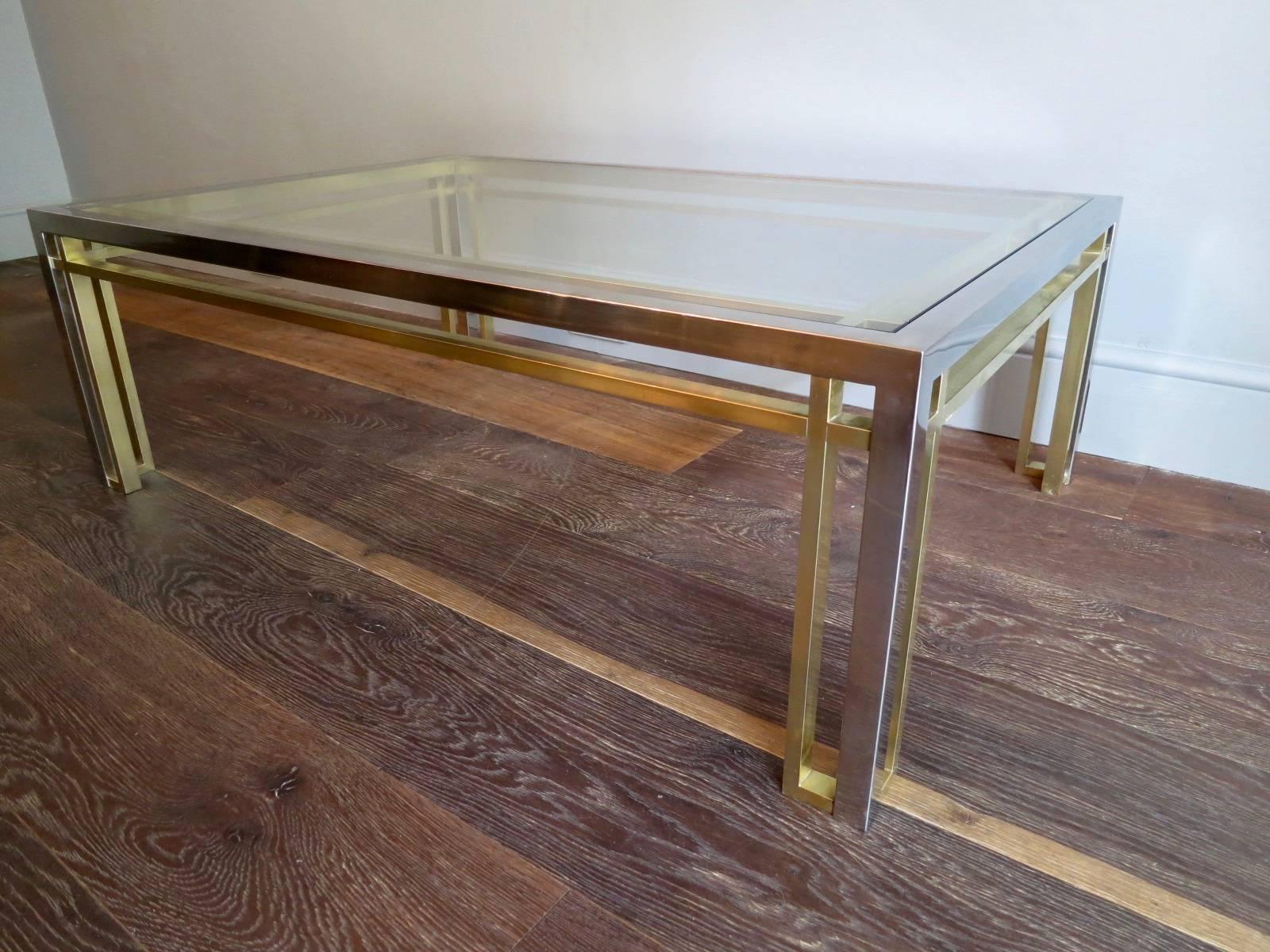 A large and low coffee table in brass and chrome with geometric design, by Romeo Rega. There are also a pair of end tables to match from this range in a separate listing, which are shown in the last image.