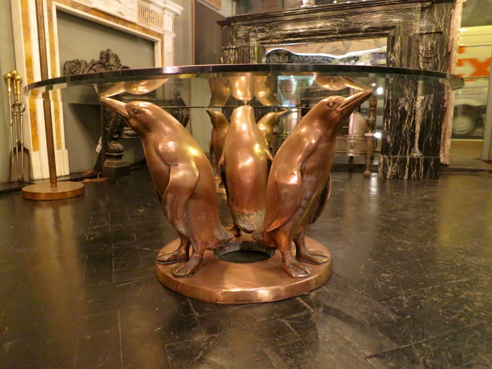 A pair of circular tables with the bases in bronze in the form of penguins by early 20th century sculptor J D'aste. The penguins very well executed and with a soft patina. Can be sold separately, both signed.