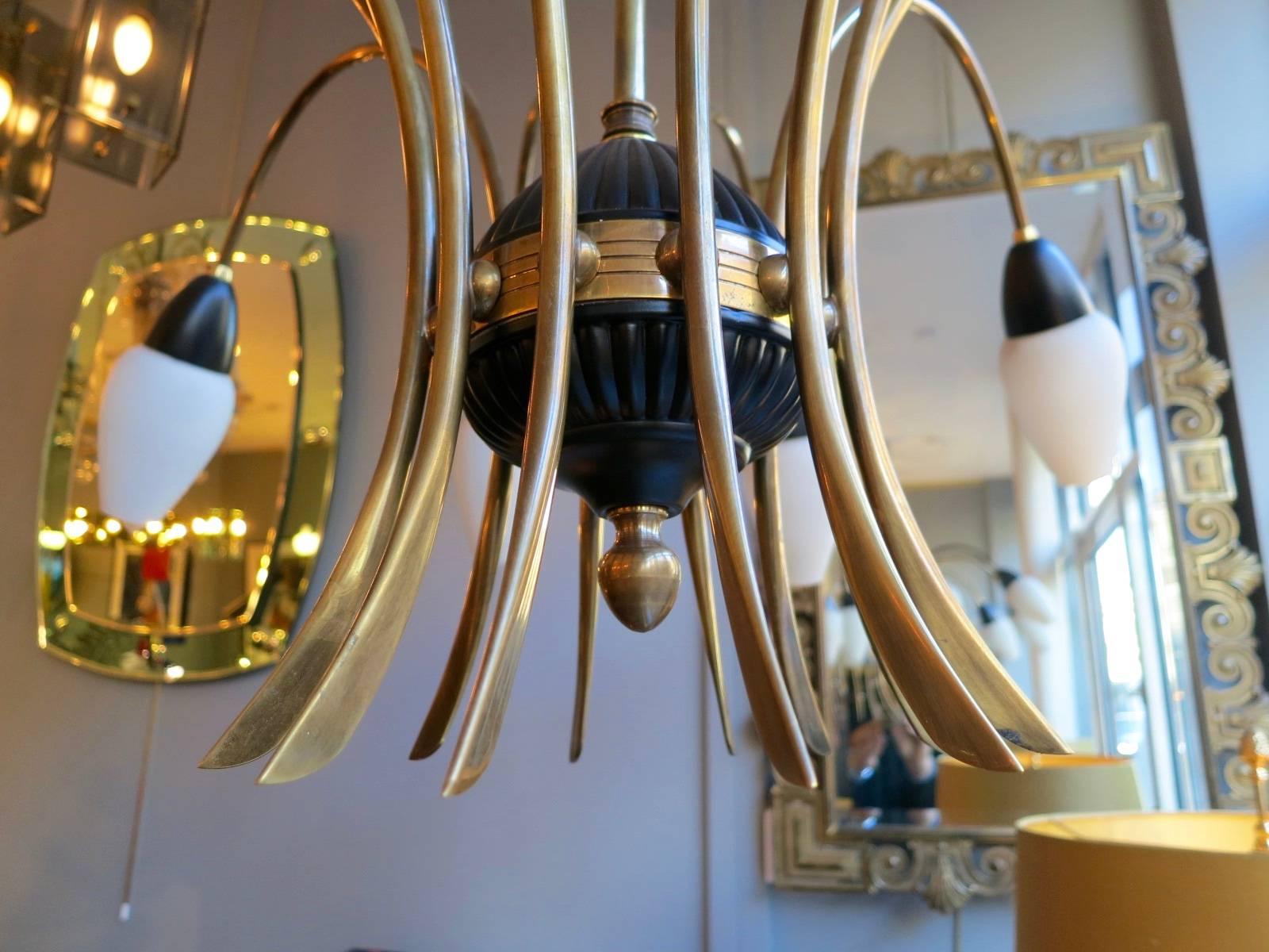 A Mid-Century Italian twelve-arm brass and black chandelier with opaque glass diffusers. Completely restored and re wired and in very good condition.