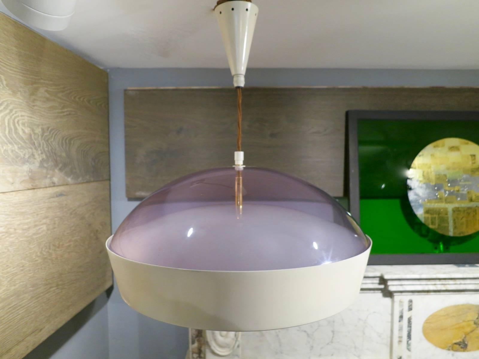A circular domed topped pendant in white lacquered metal with frosted glass shade beneath and purpled domed top above. Having six light fittings and brass accents. The silk cord allowing a much longer drop if required. A well designed and quality
