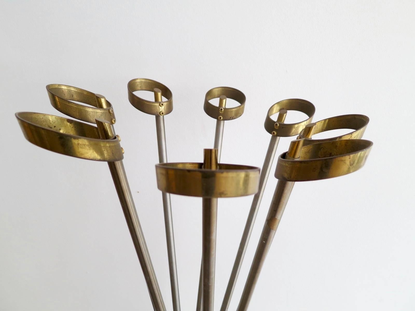 A brass and steel stand with twisted steel supports and circular brass accents.