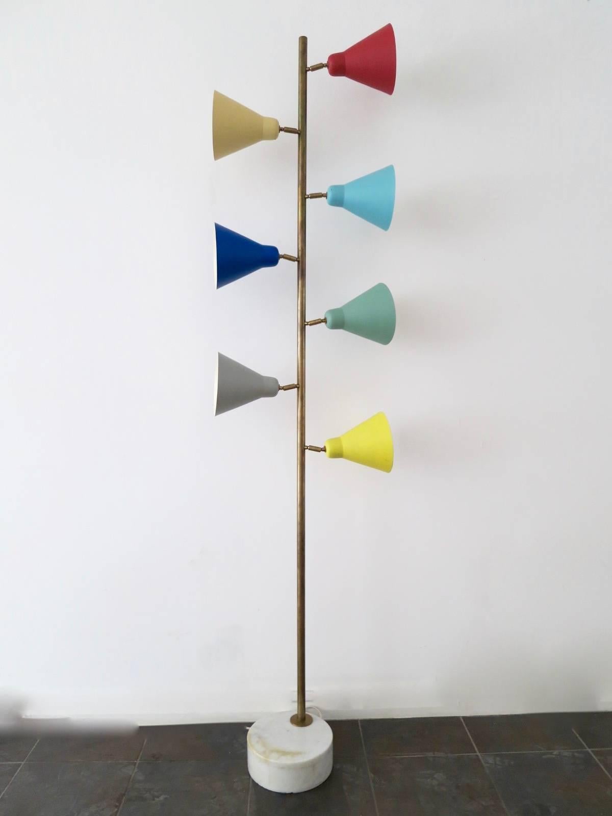A very tall and substantial floor lamp in the Mid-Century manner, with heavy marble base, brass stem and seven multi colored and positional shades. In the manner of Sarfatti.