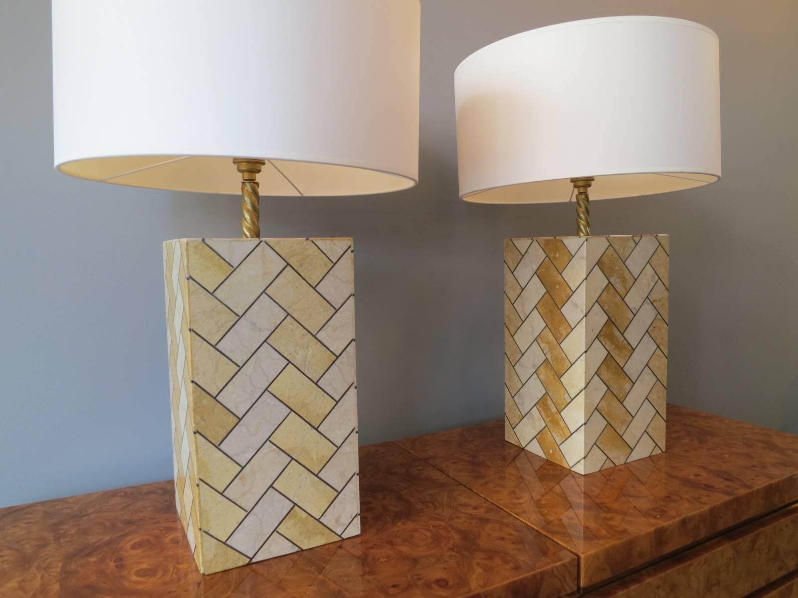 A pair of inlaid herringbone patterned table lamps in marble and brass with circular white shades and silk flex, late 20th century

Sizes given including shade.